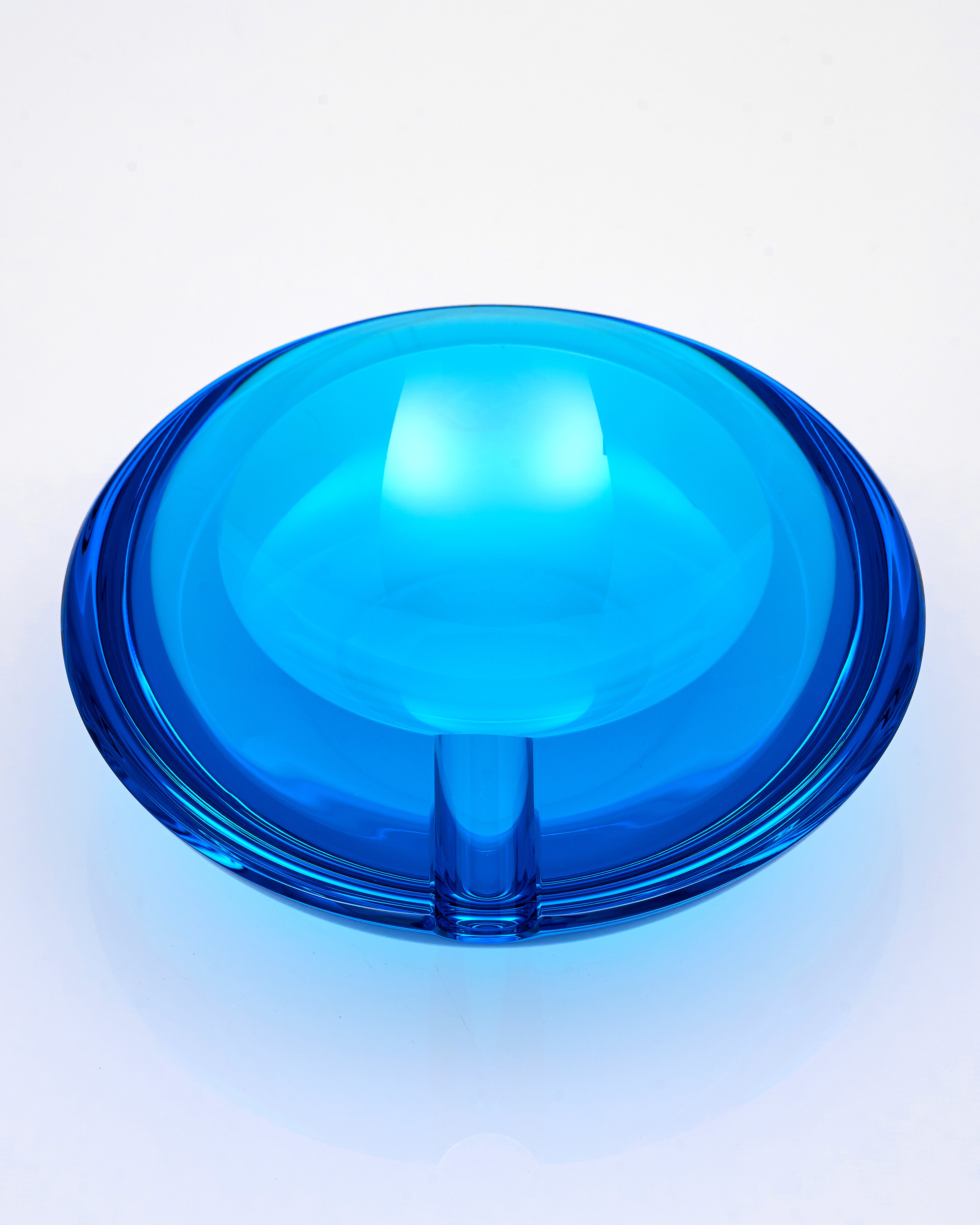 Blue crystal glass ashtray on a white background