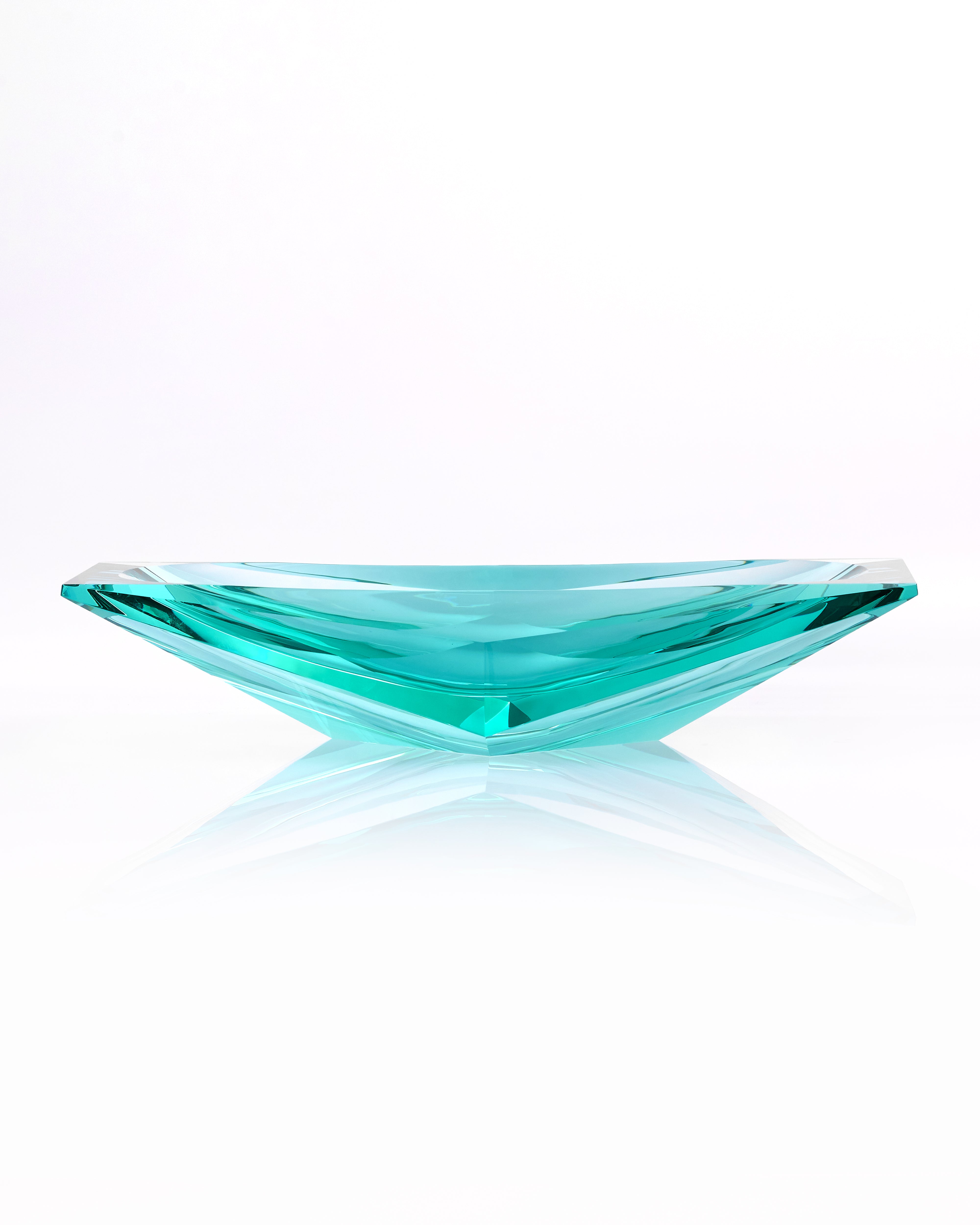Turquoise crystal bowl on a white background