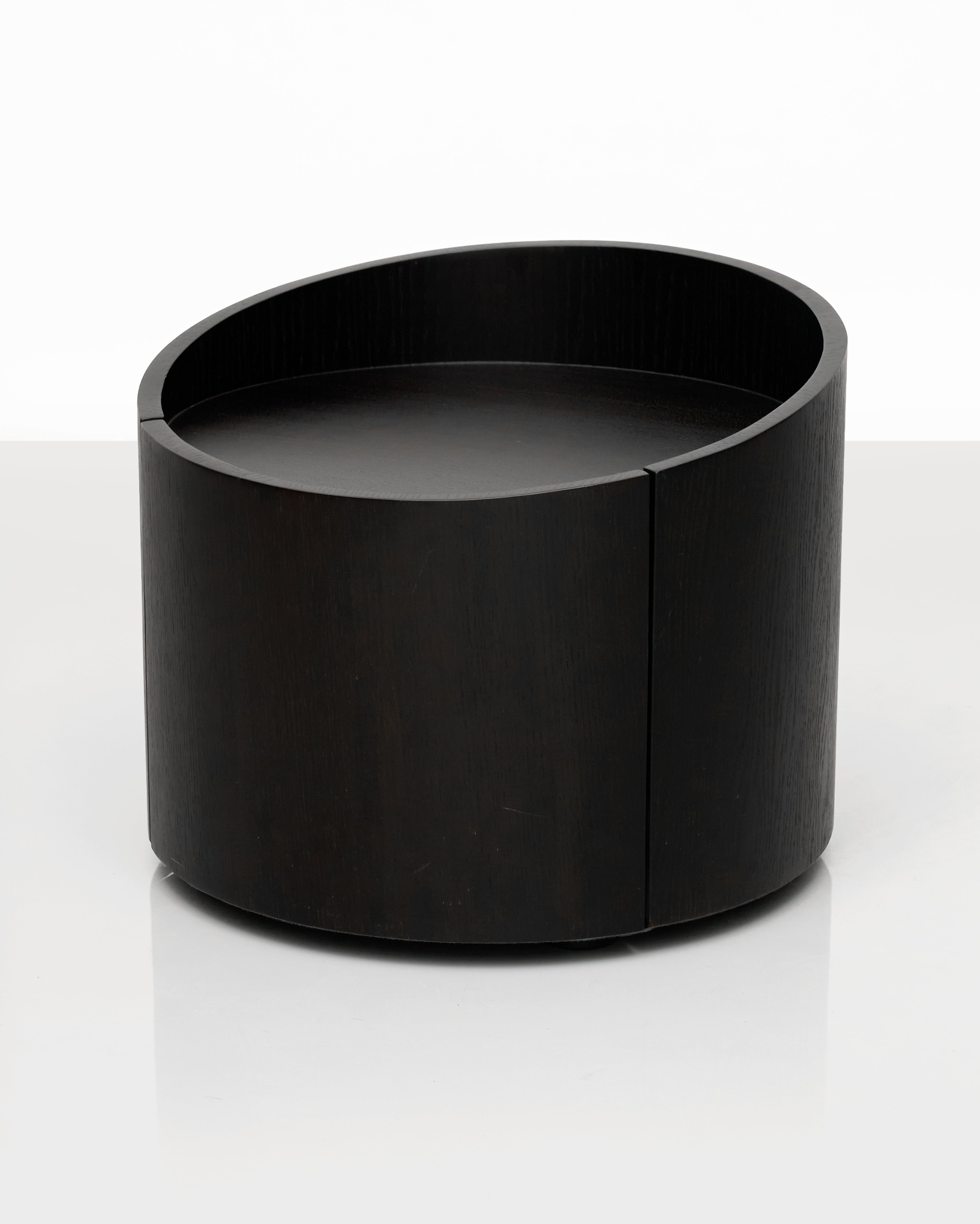 Black cylindrical side table on a white background