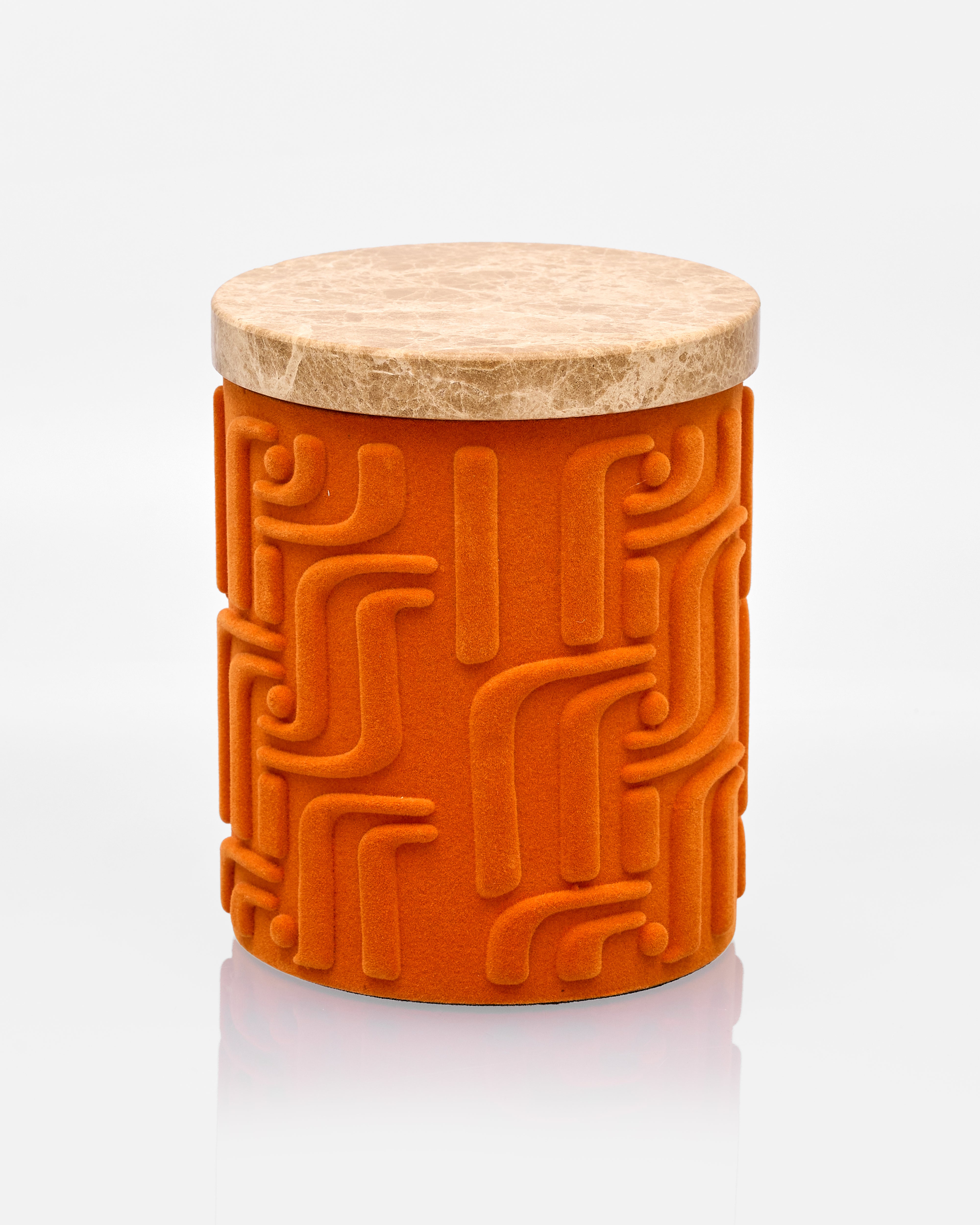 Orange textured jar with a marble lid on a white background