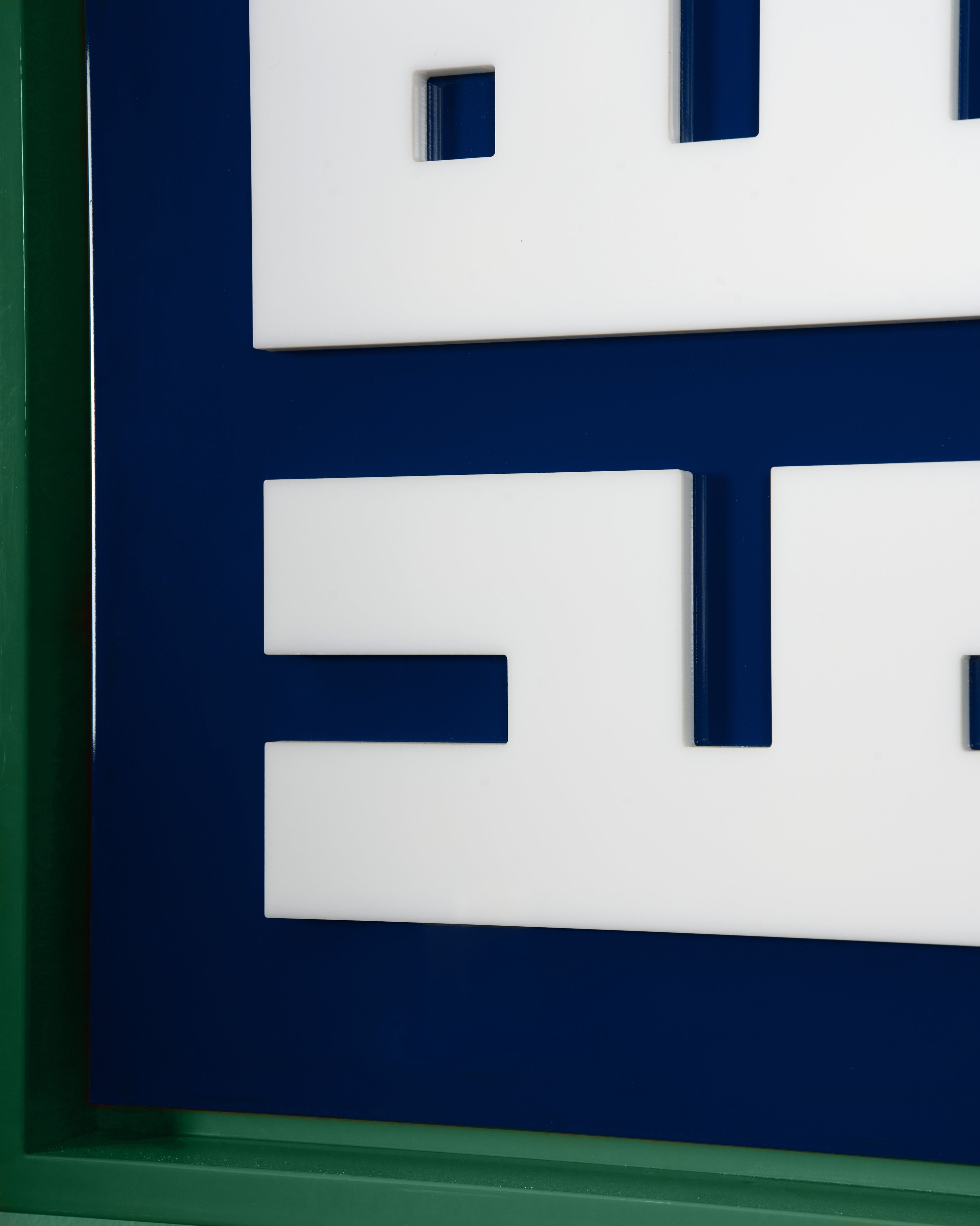 Close-up of a geometric design with blue and white shapes on a dark blue background.