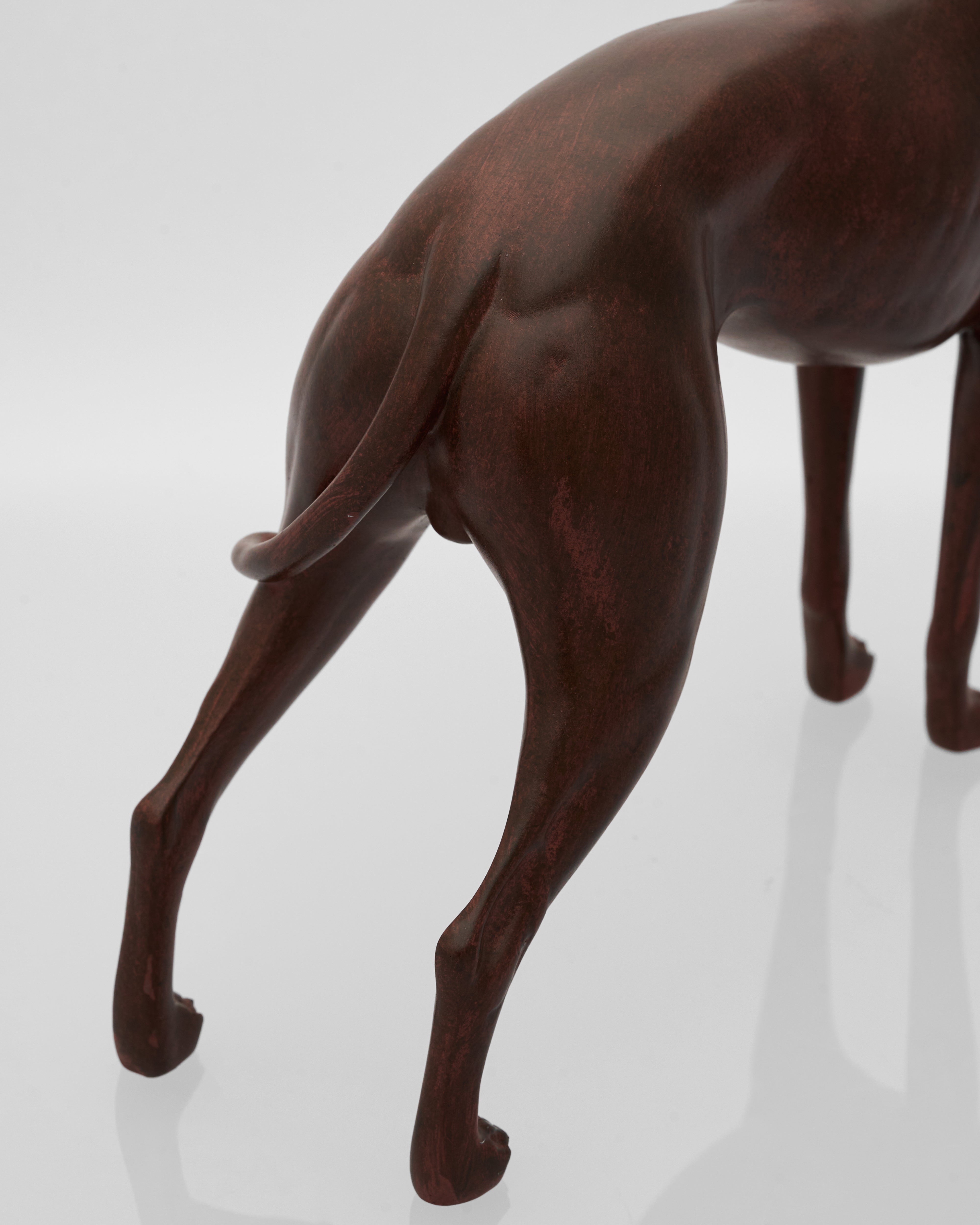 wooden brown sculpture of a dog on a white background