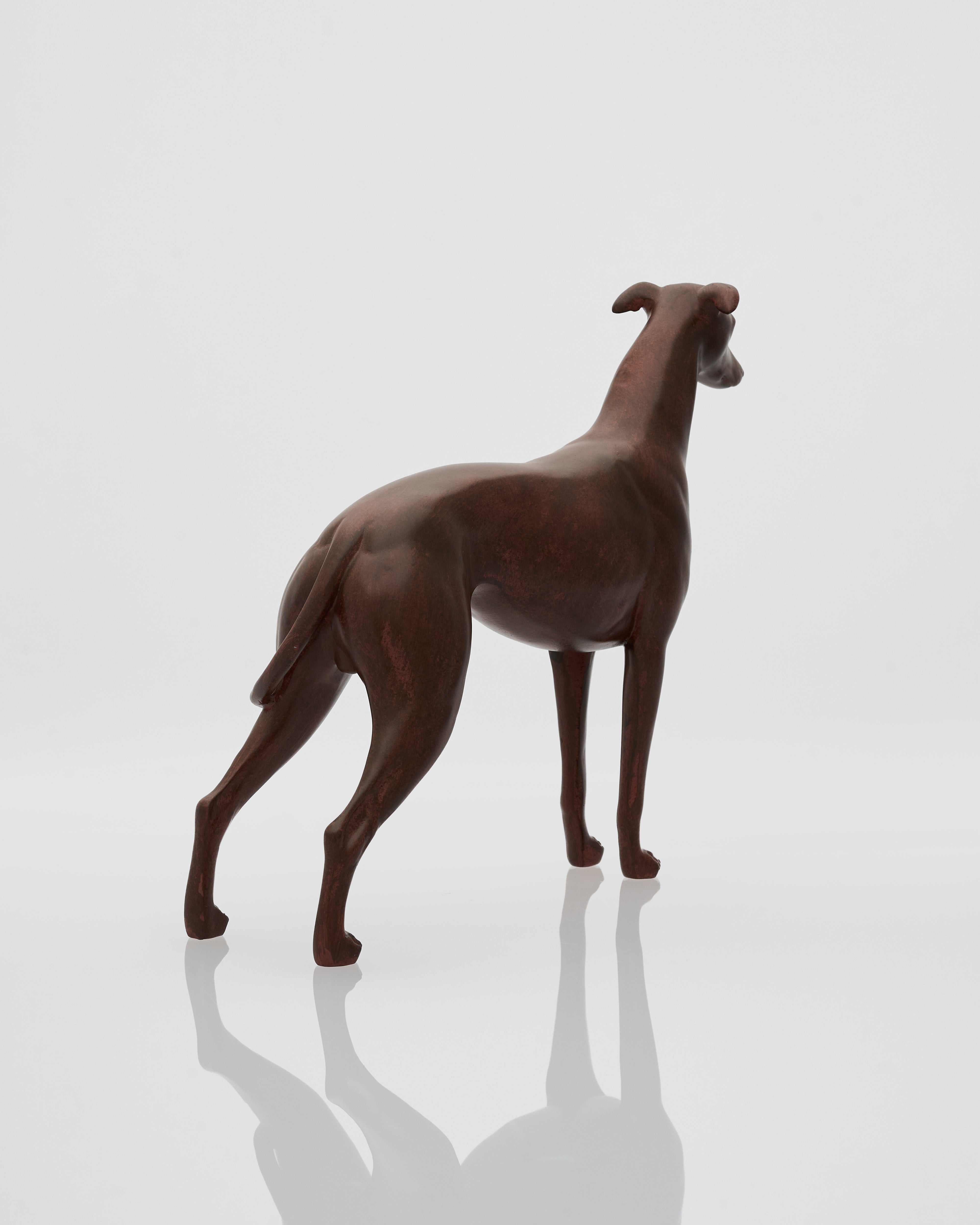 Brown wooden dog figurine on a reflective white surface