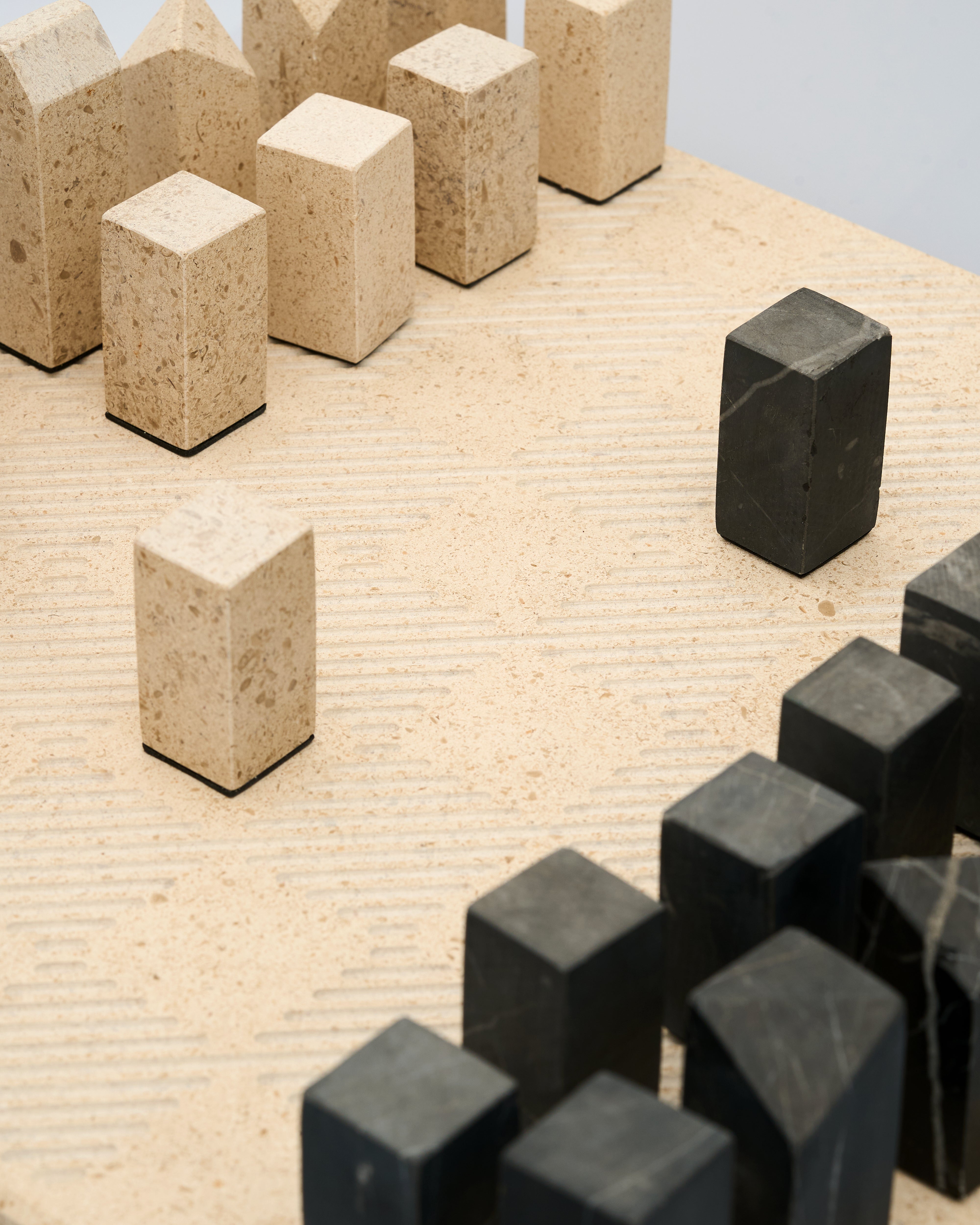 Beige and black cube-shaped objects on a textured surface
