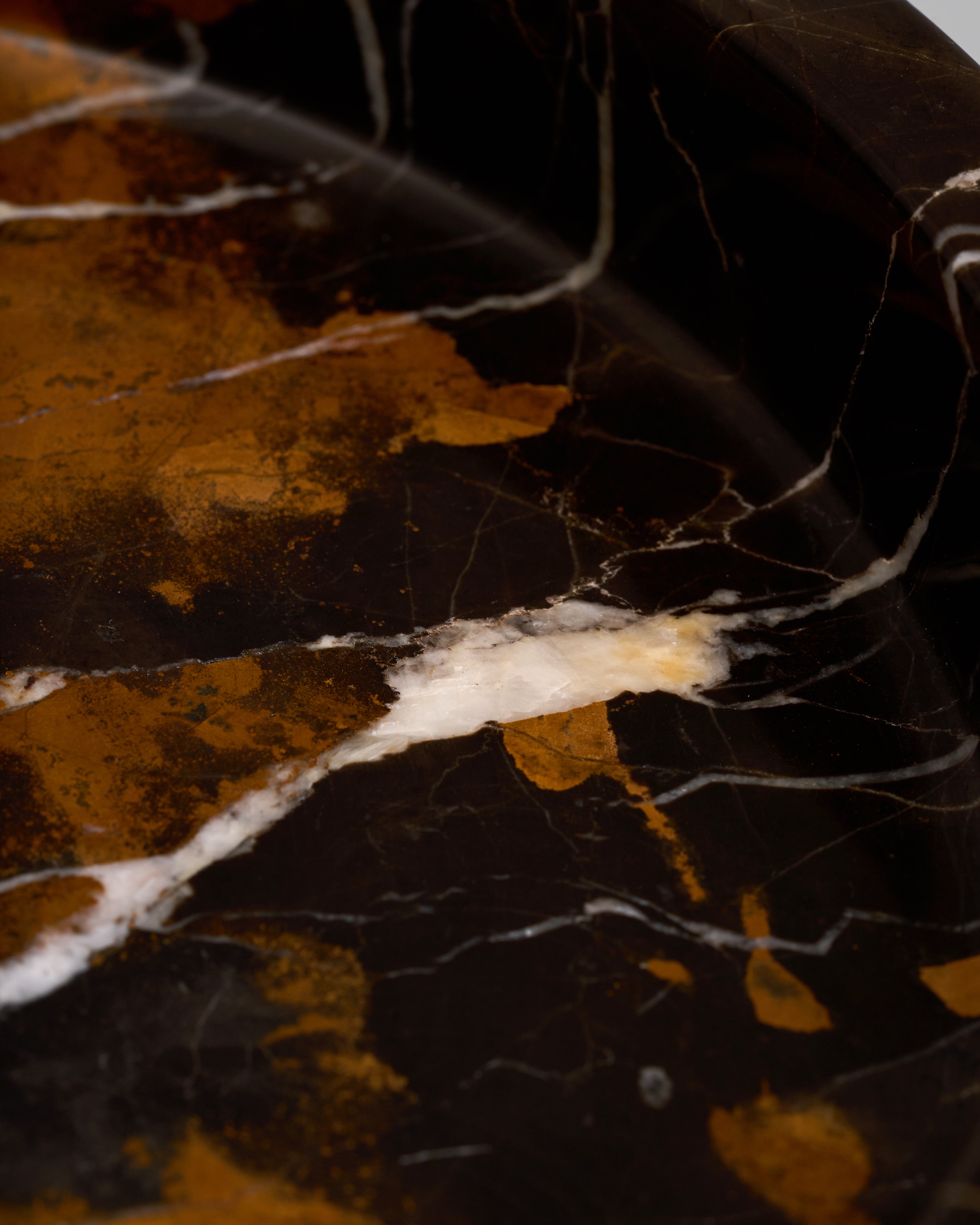 Close-up of a marbled surface with brown, black, and white colors.