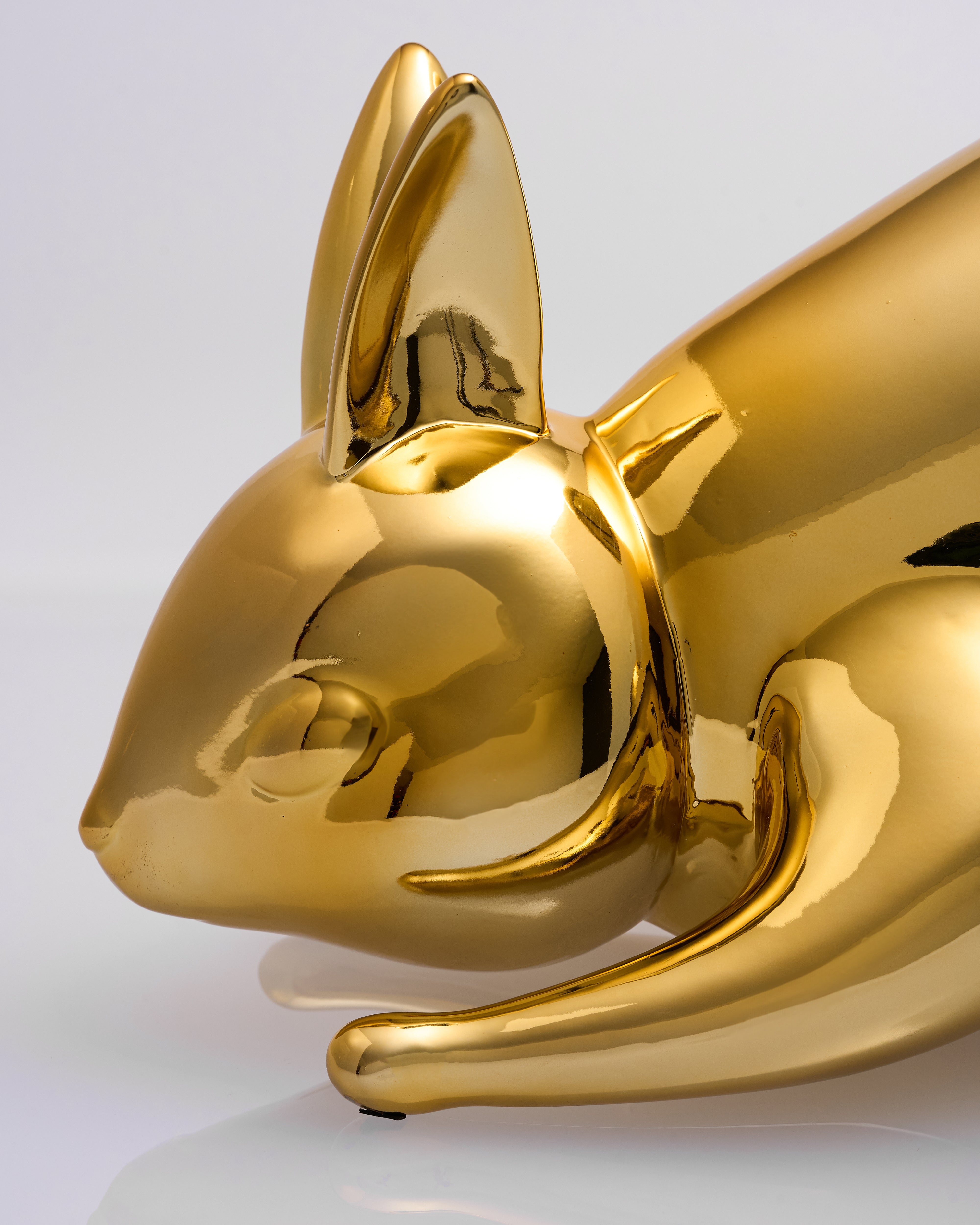 Gold rabbit sculpture on a white background