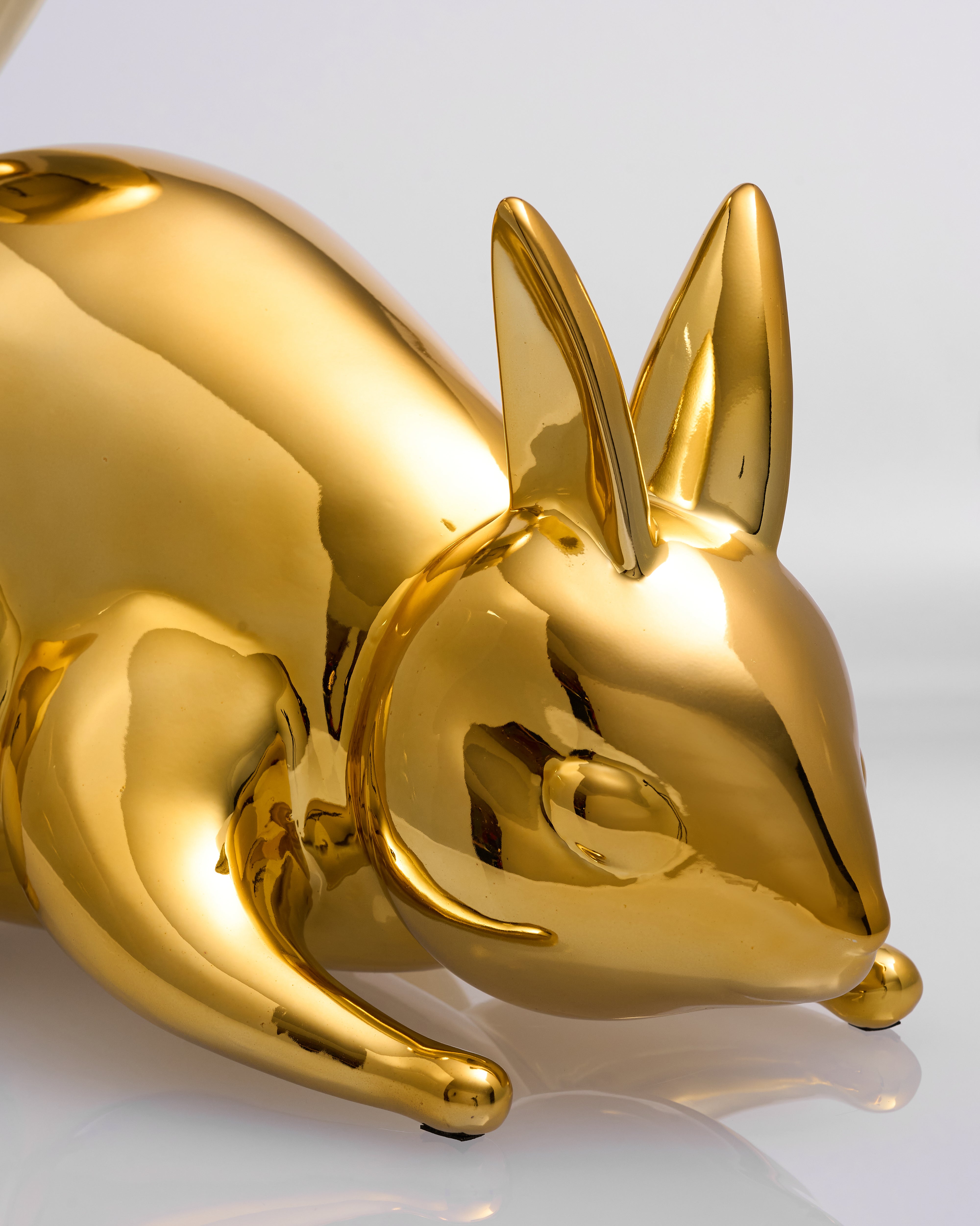 Gold rabbit-shaped object on a white background