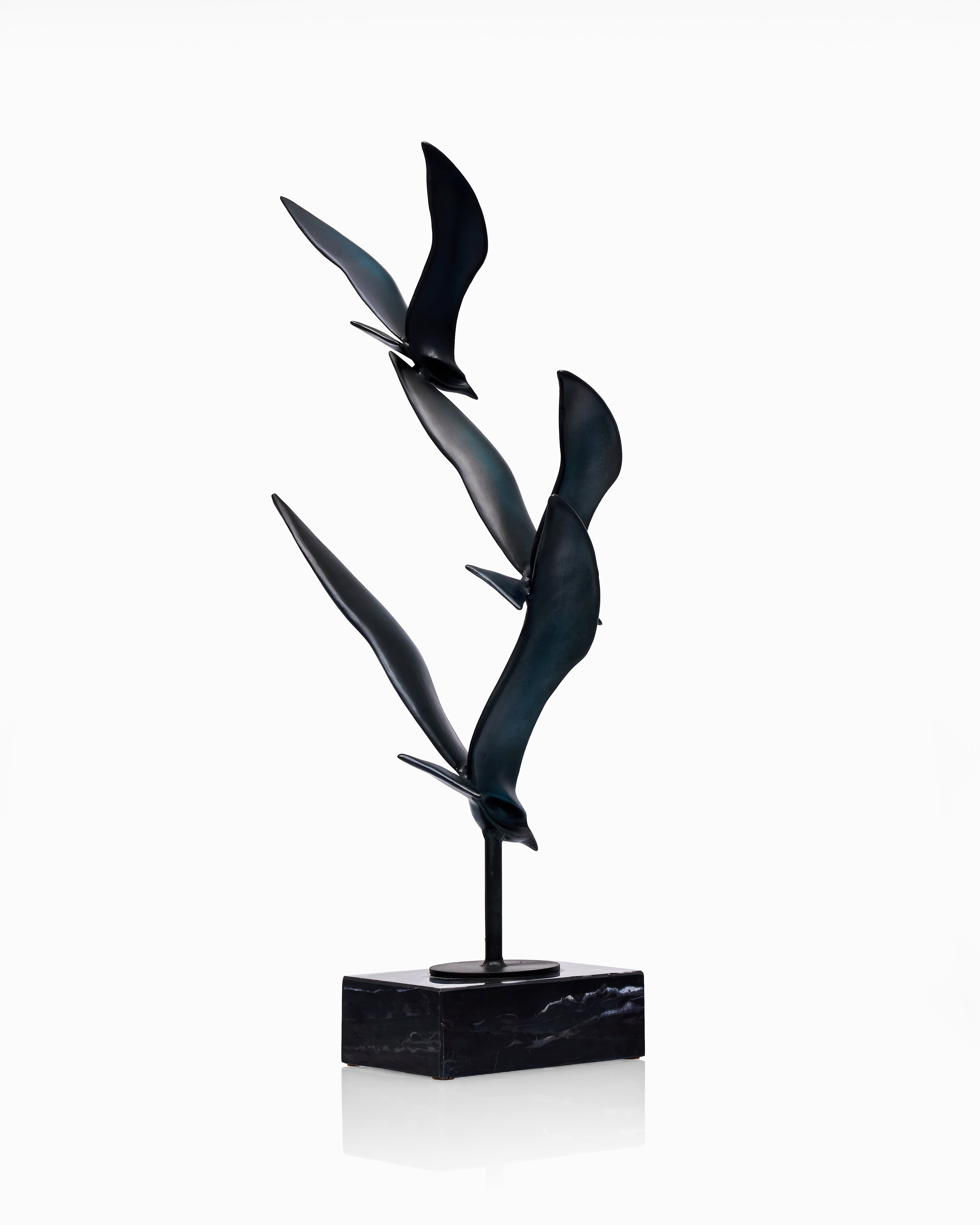 Black abstract bird sculpture on a white background
