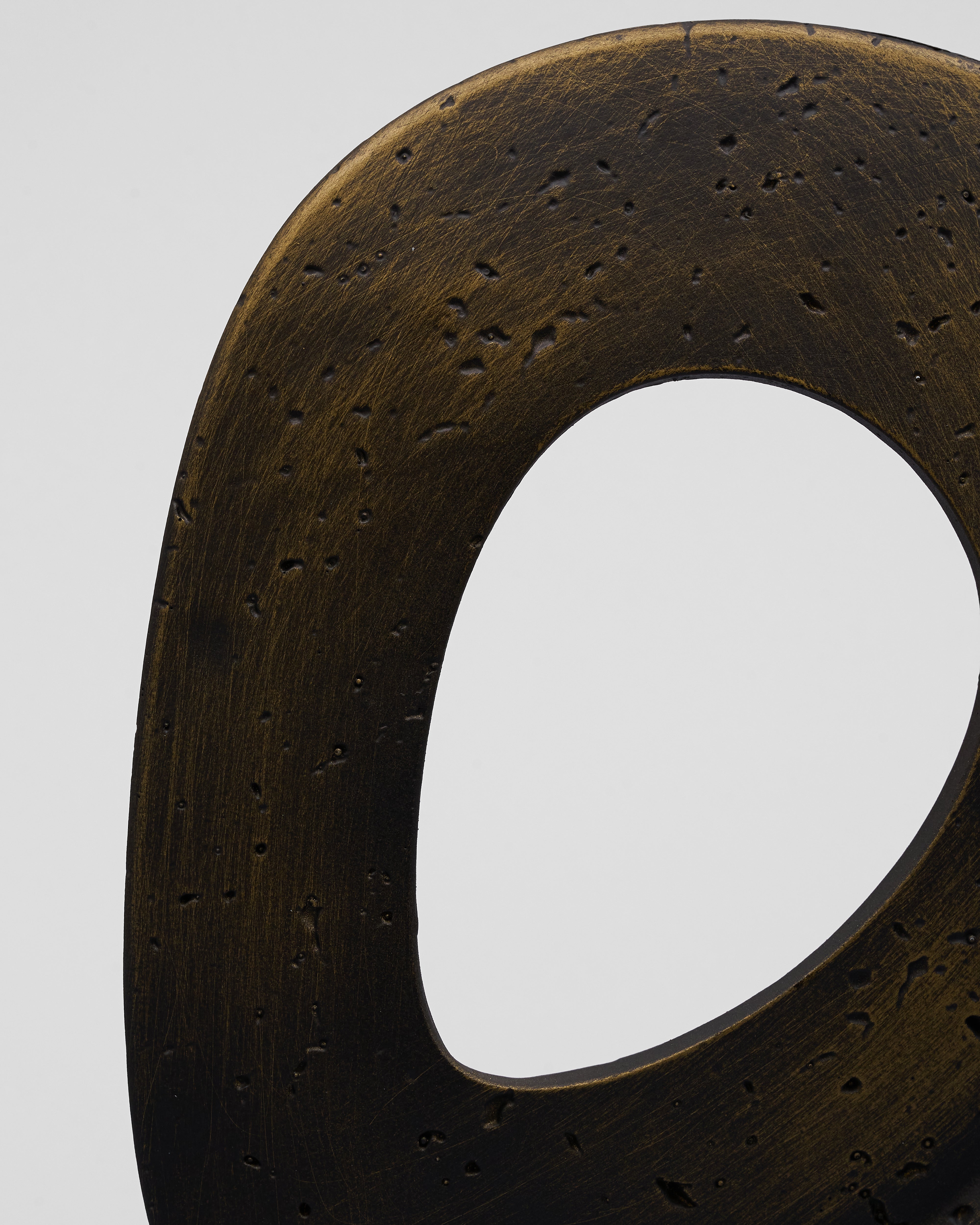Close-up of a dark brown leather belt with a white center on a light gray background