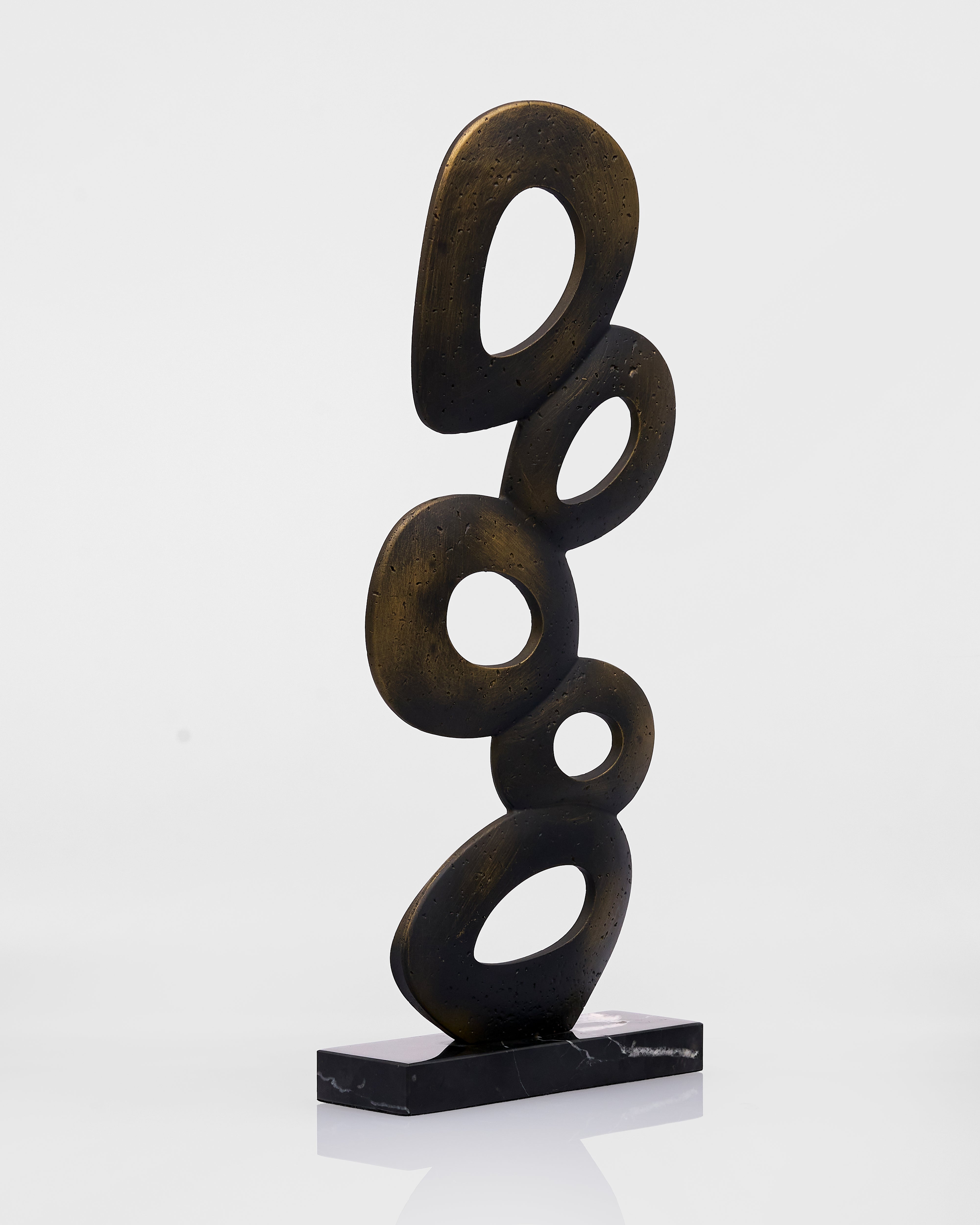 Abstract sculpture with interconnected loops on a white background