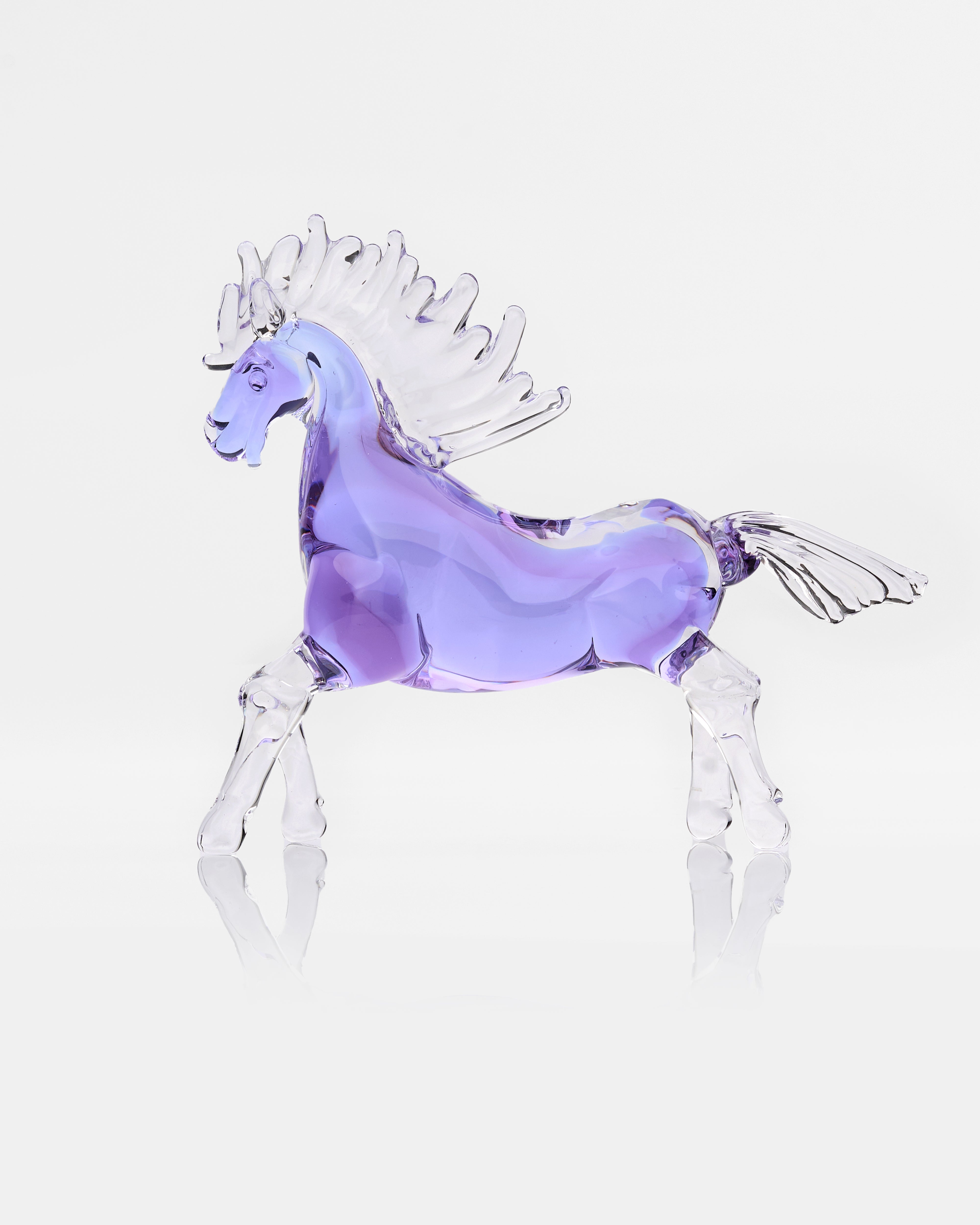 Glass horse figurine with a purple body on a white background