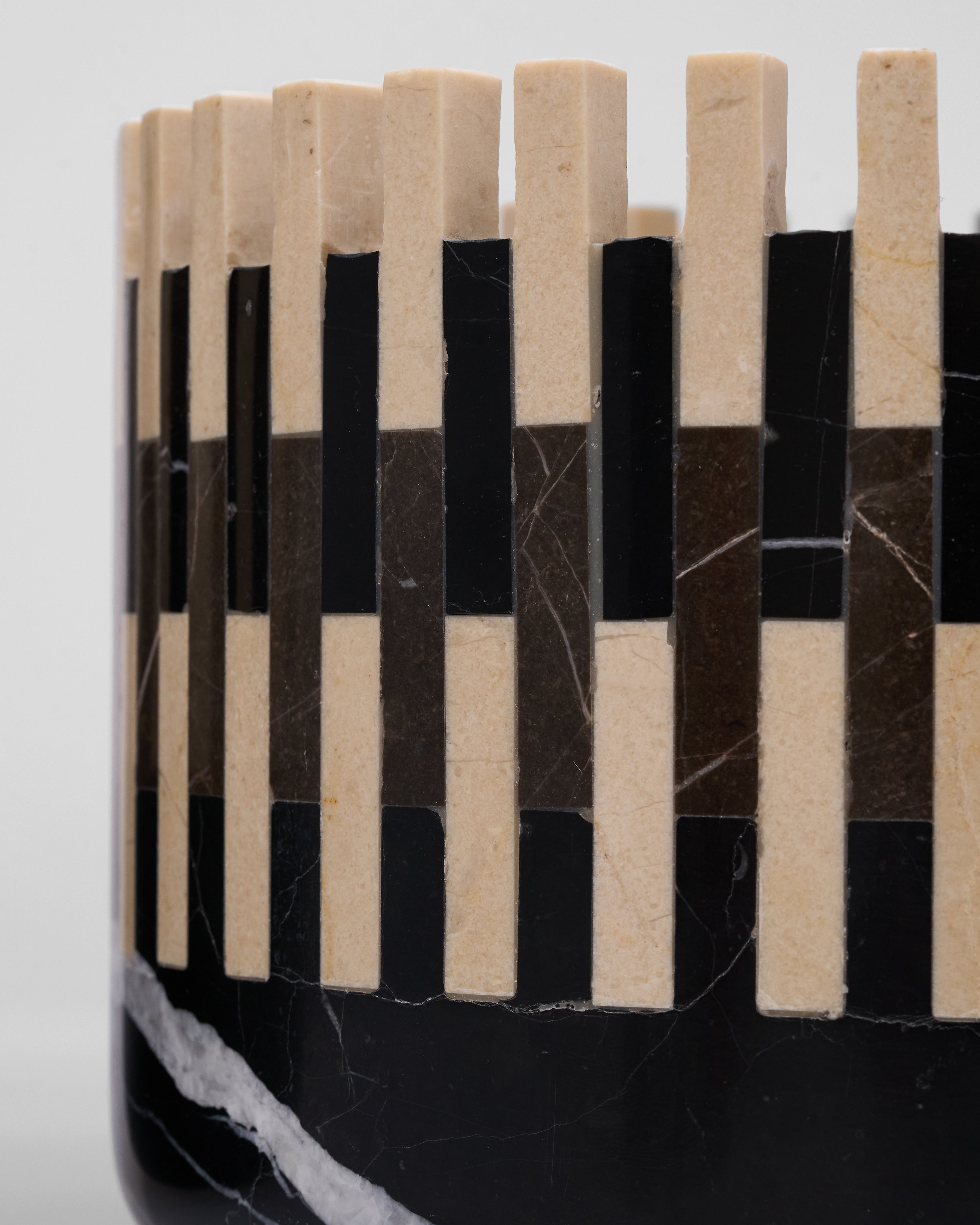 Close-up of a black and beige patterned product on a white background