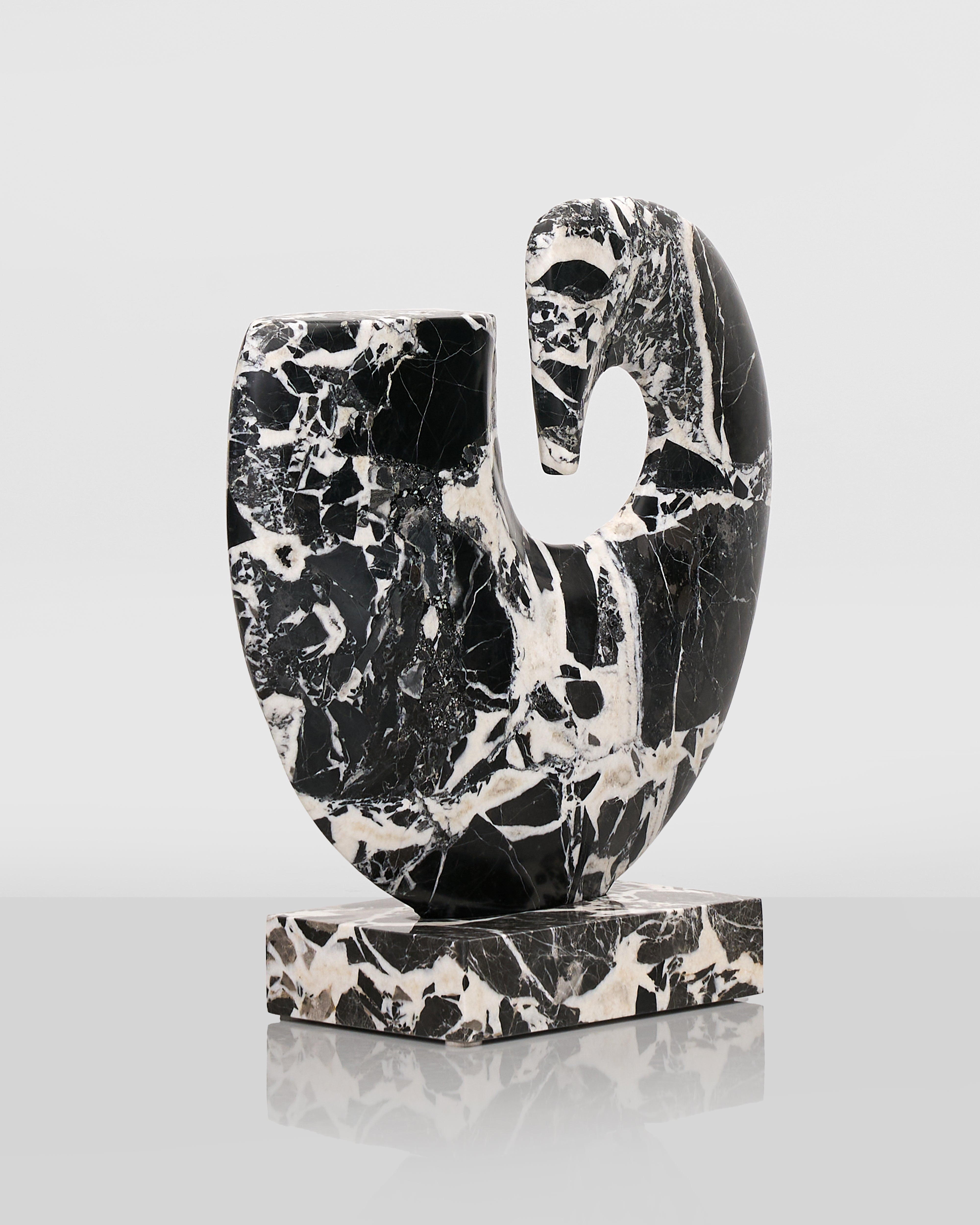Black and white marble sculpture on a light gray background
