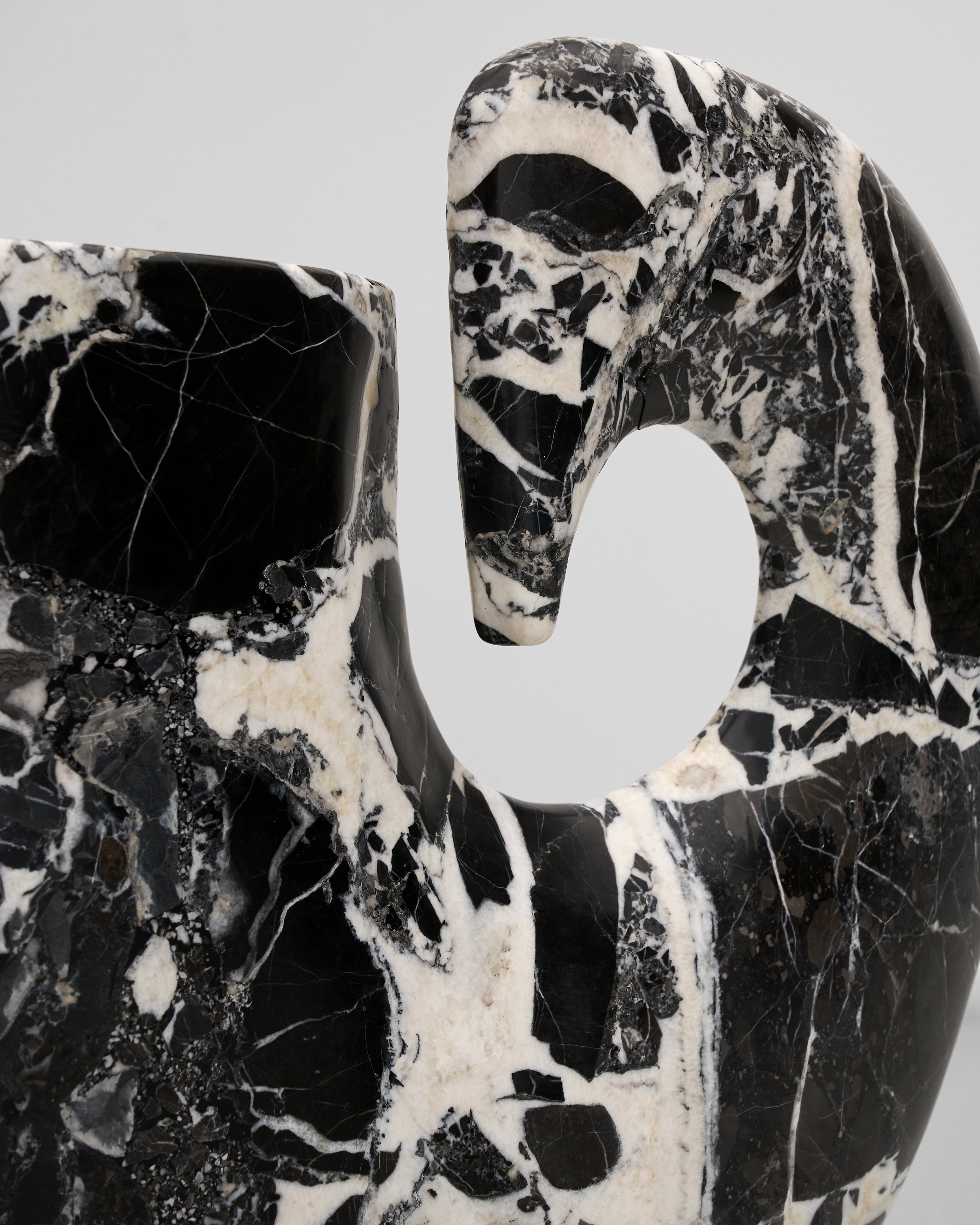 Marble-patterned object with a white center on a light gray background