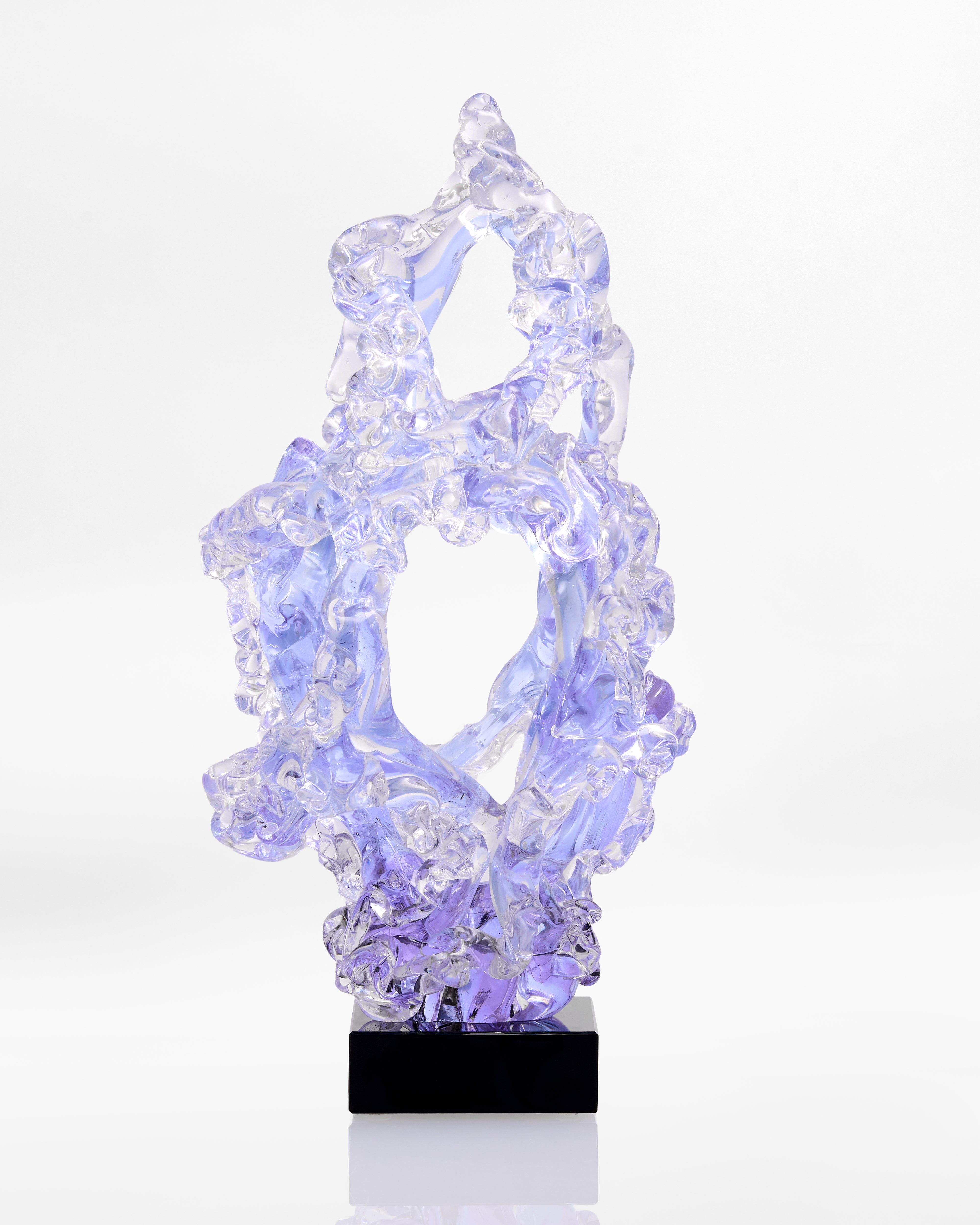 Crystal-like object on a black base against a white background