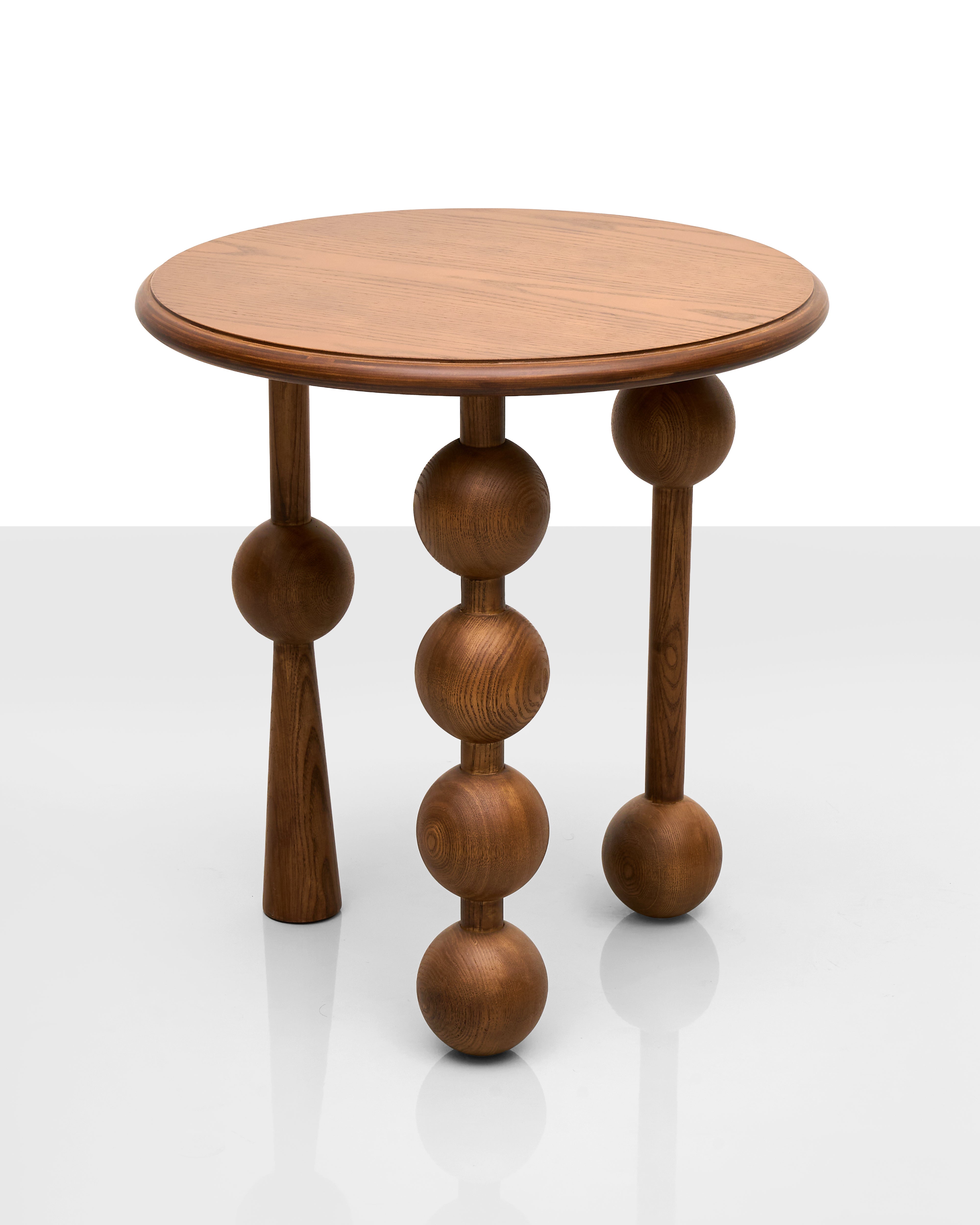 Wooden side table with spherical design on a white background