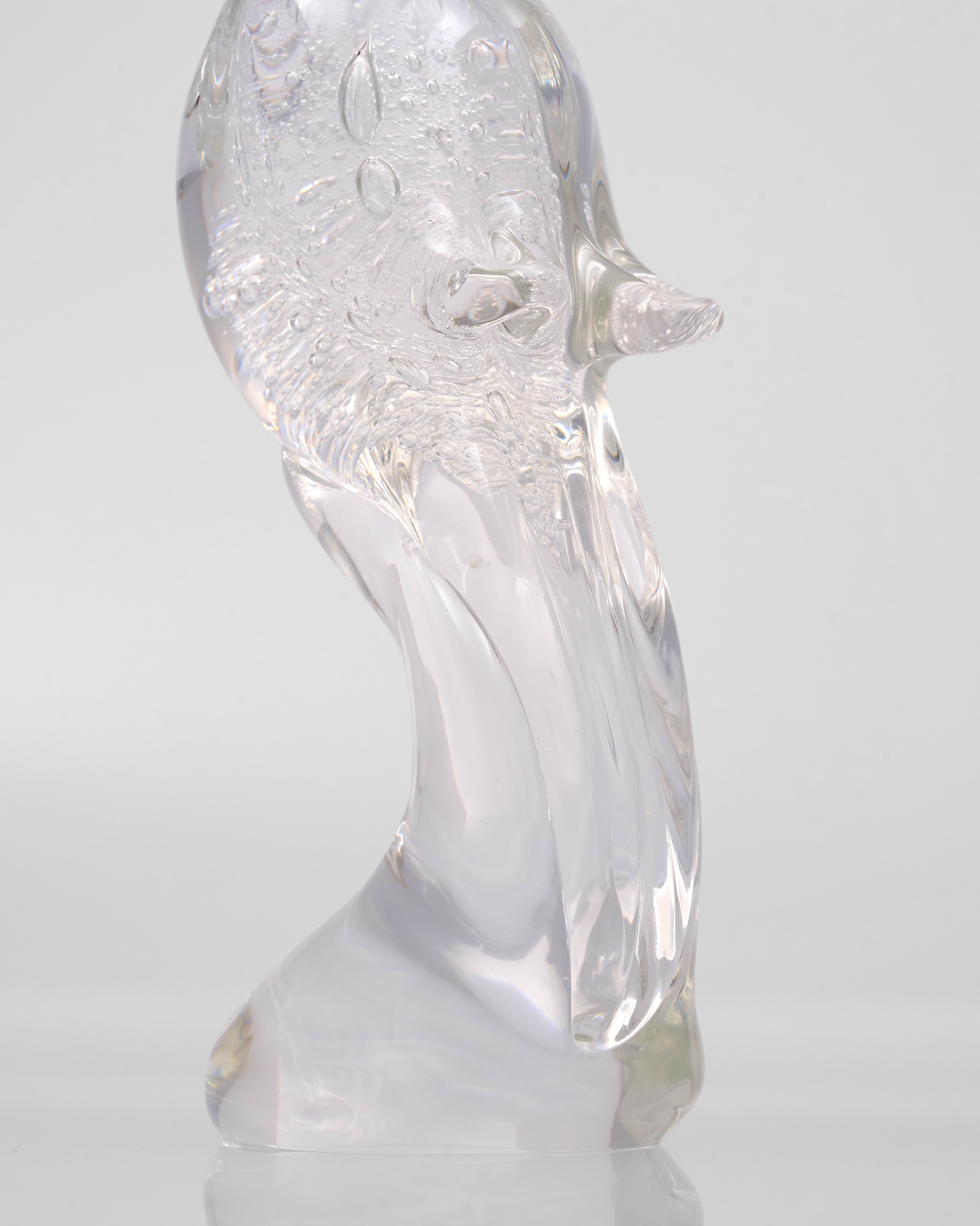 Clear glass sculpture of a rooster on a white background