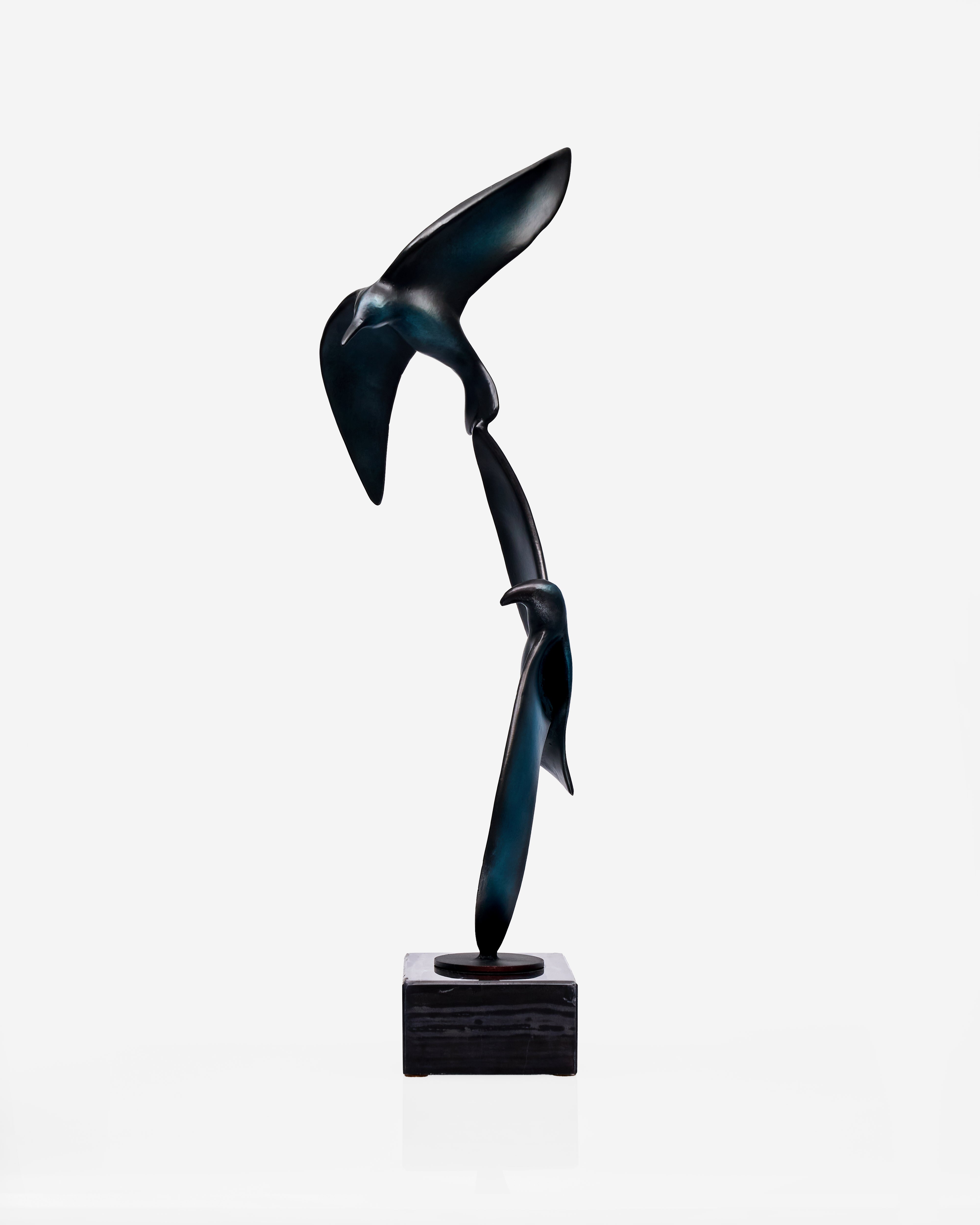 Abstract sculpture of two birds on a white background