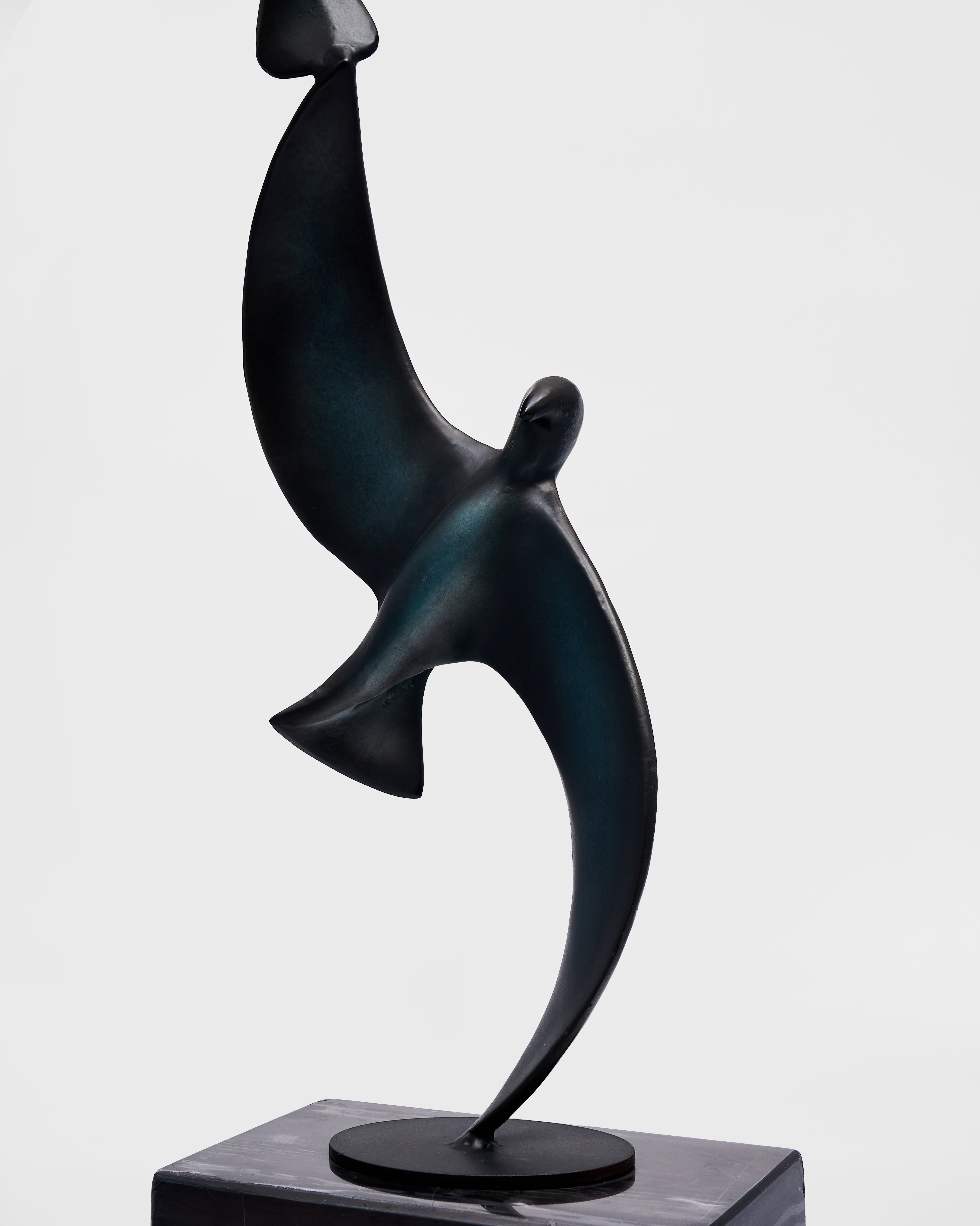 Abstract black bird sculpture on a gray background