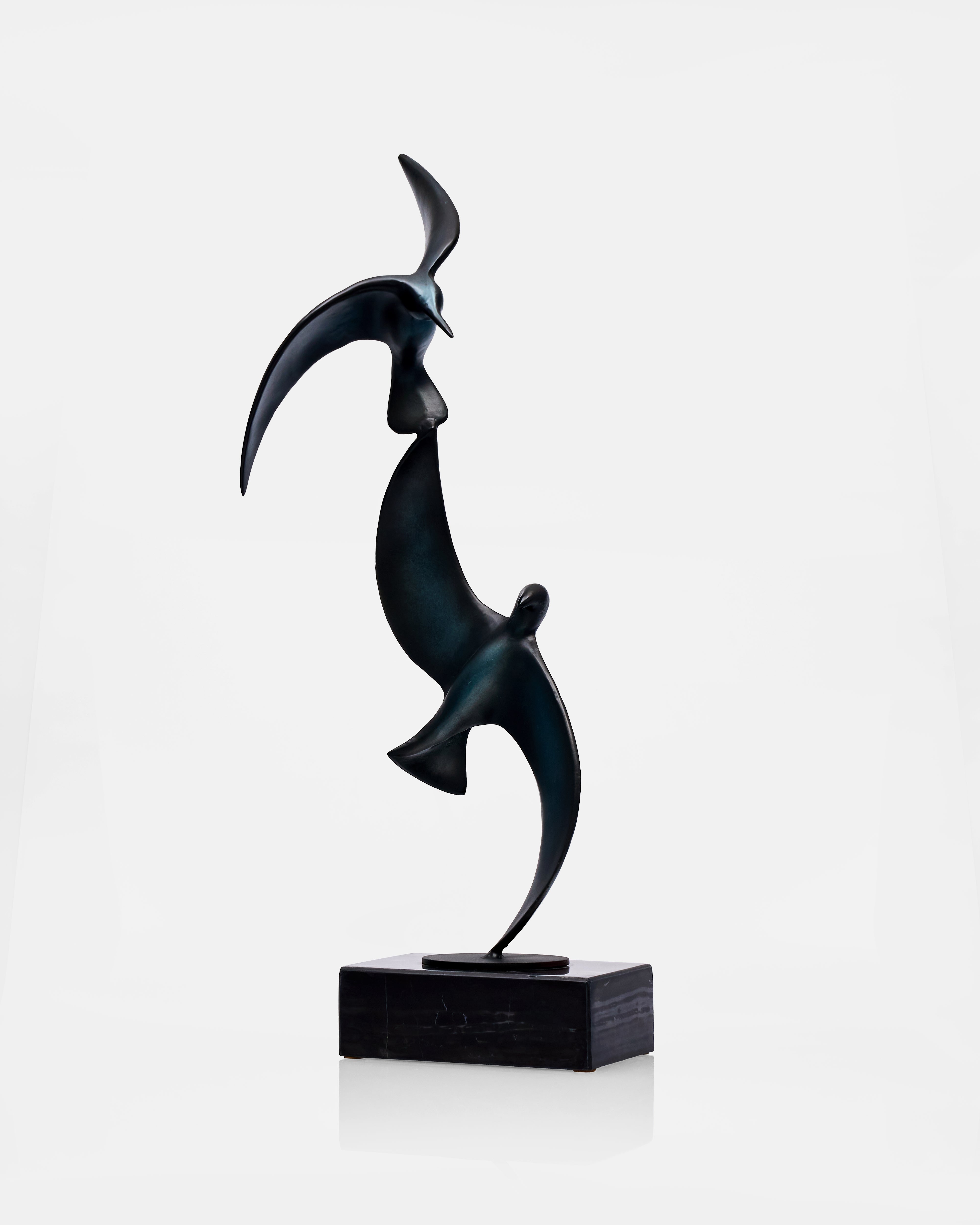 Abstract black sculpture of two birds on a white background