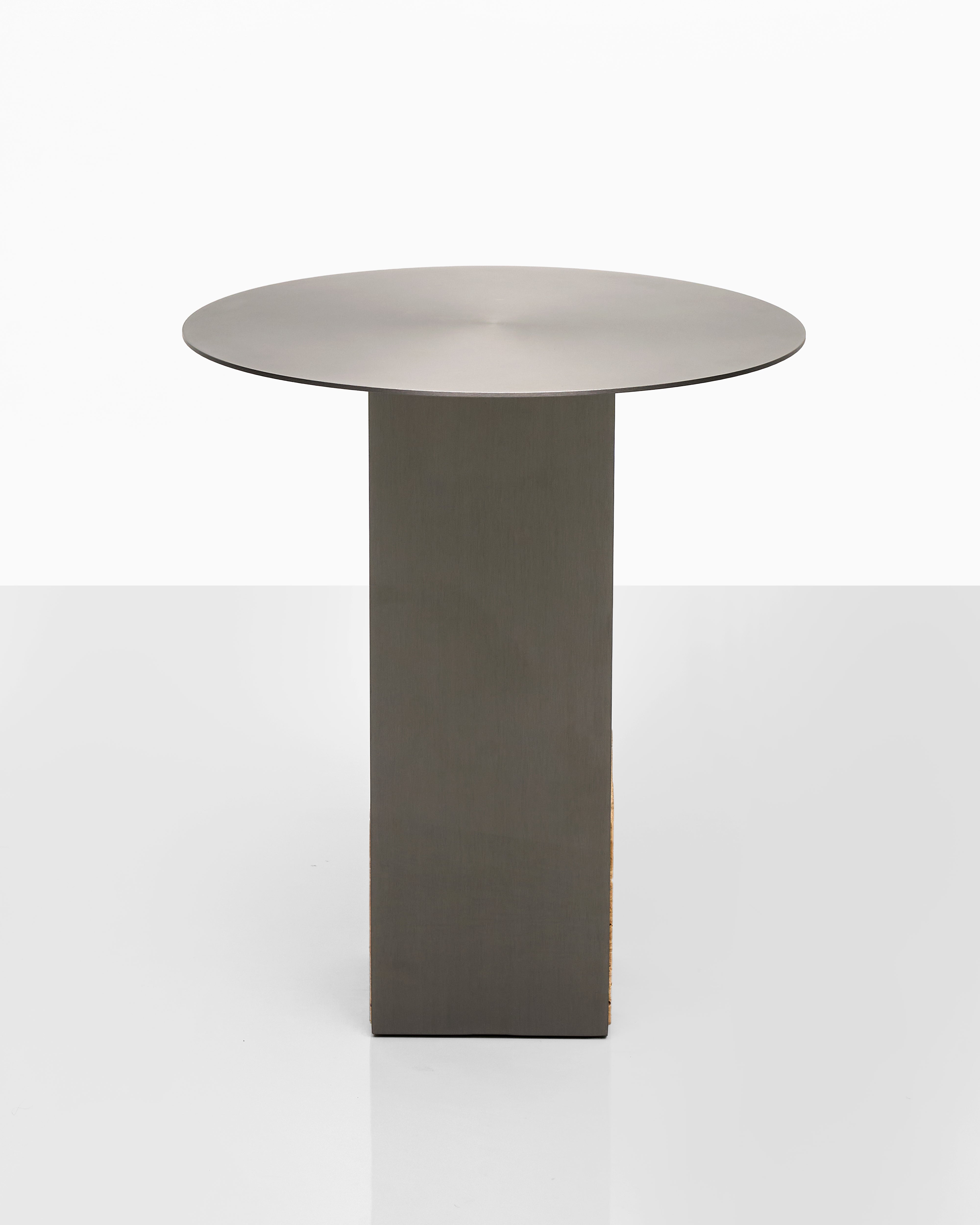 Modern side table with a metallic finish on a white background