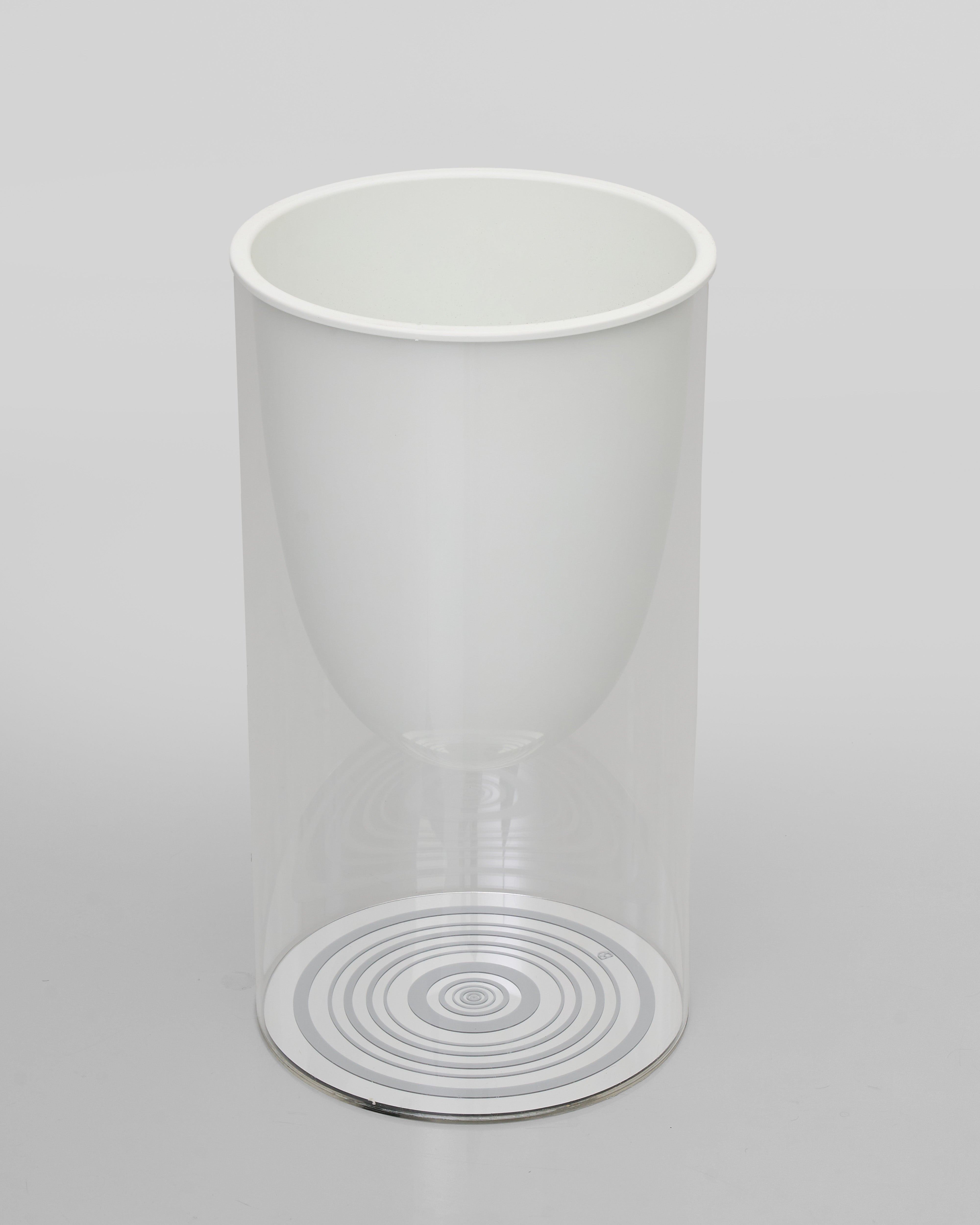 Clear white larger vase with circular pattern on a light gray background