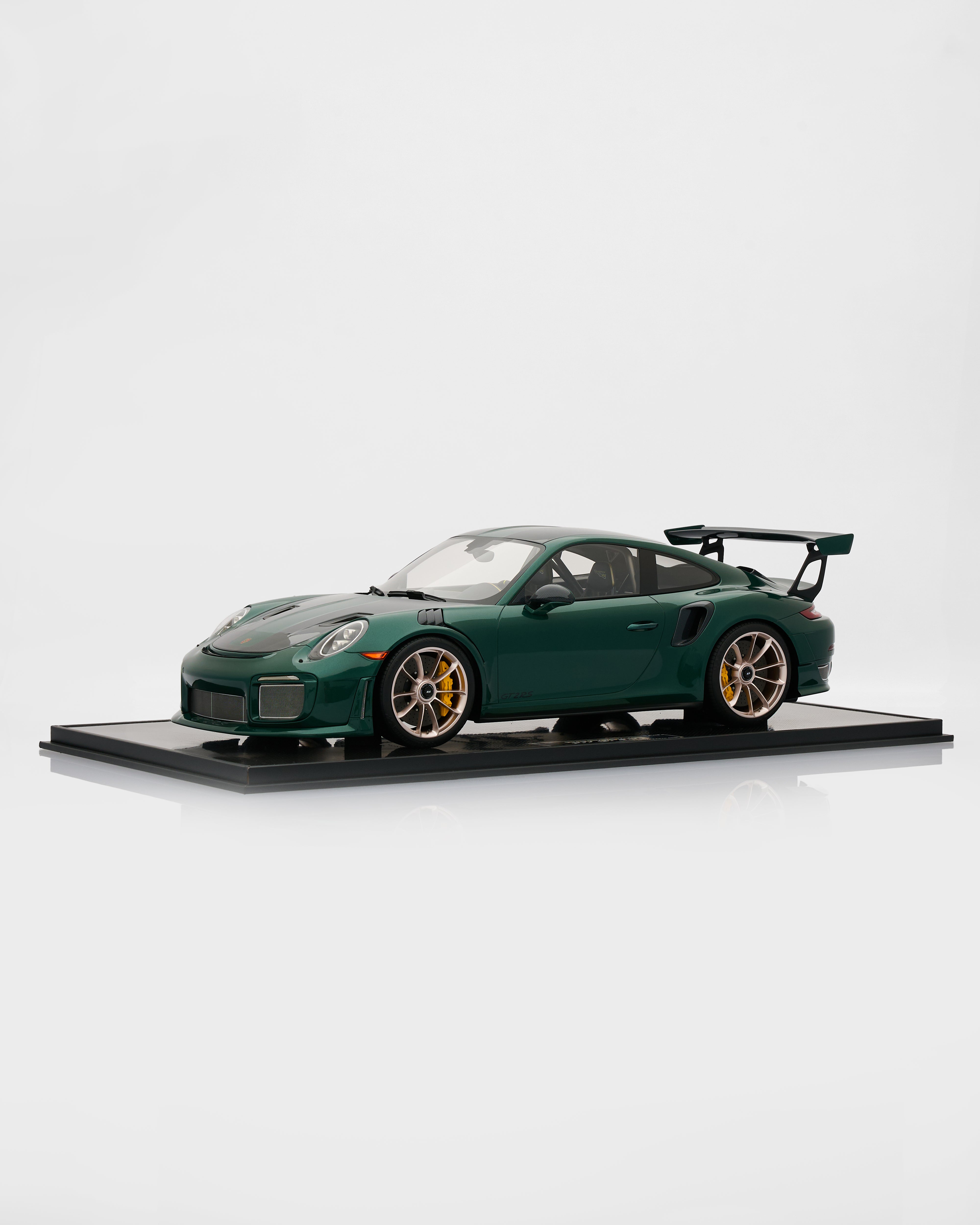 Model of a green sports car on a white background