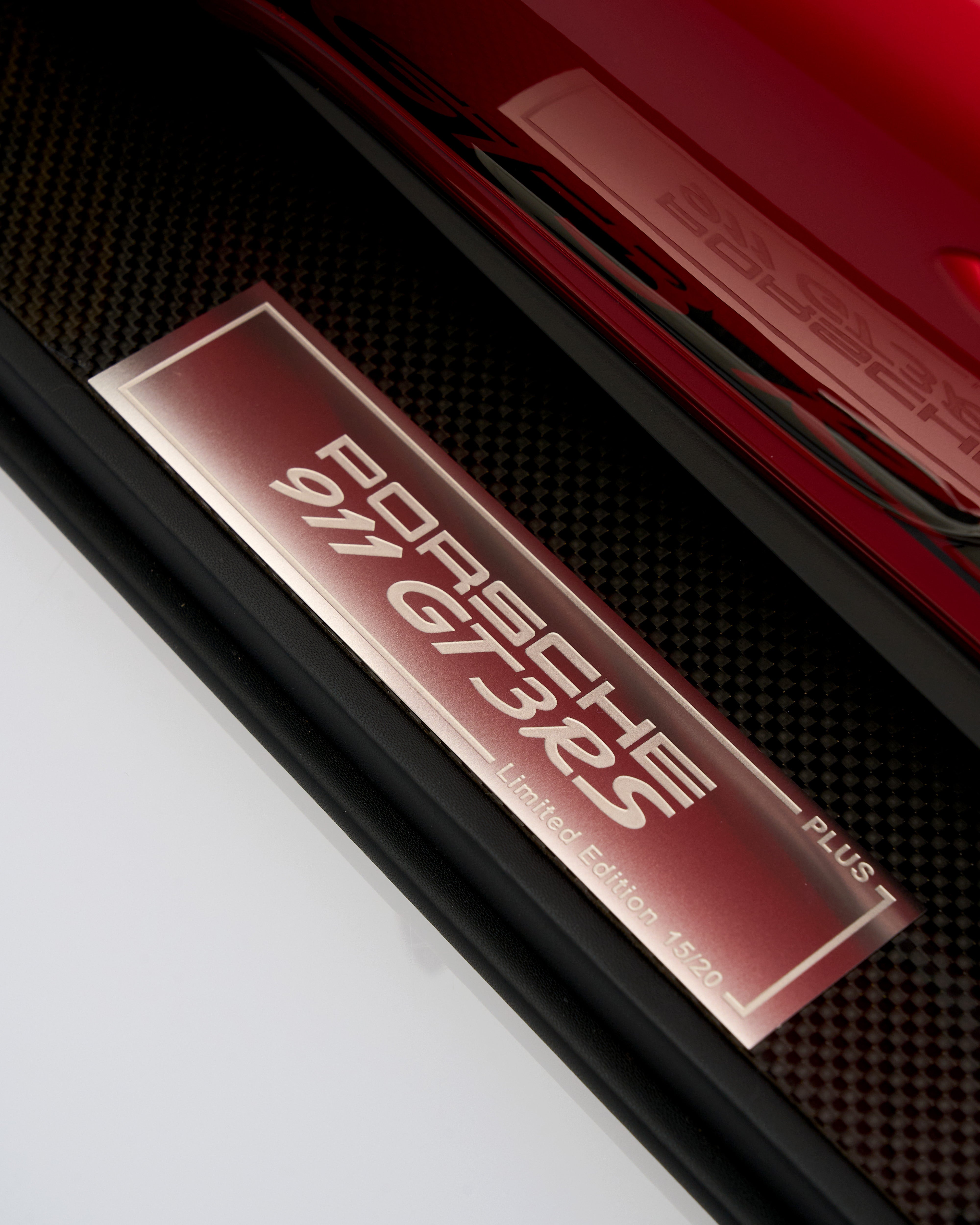 Close-up of a Porsche 911 GT3 RS badge on a car door.