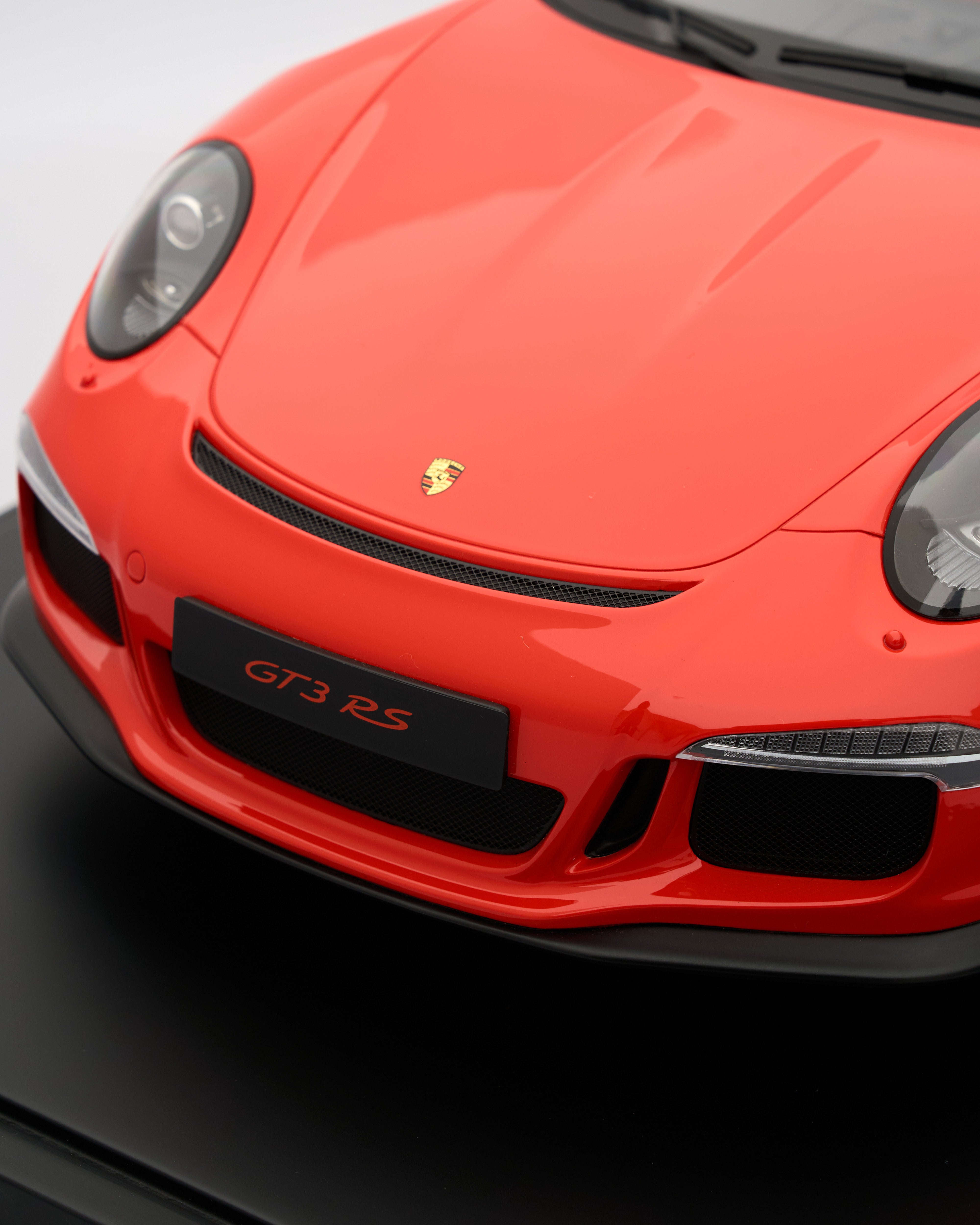 Close-up of a red Porsche GT3 RS car on a black background