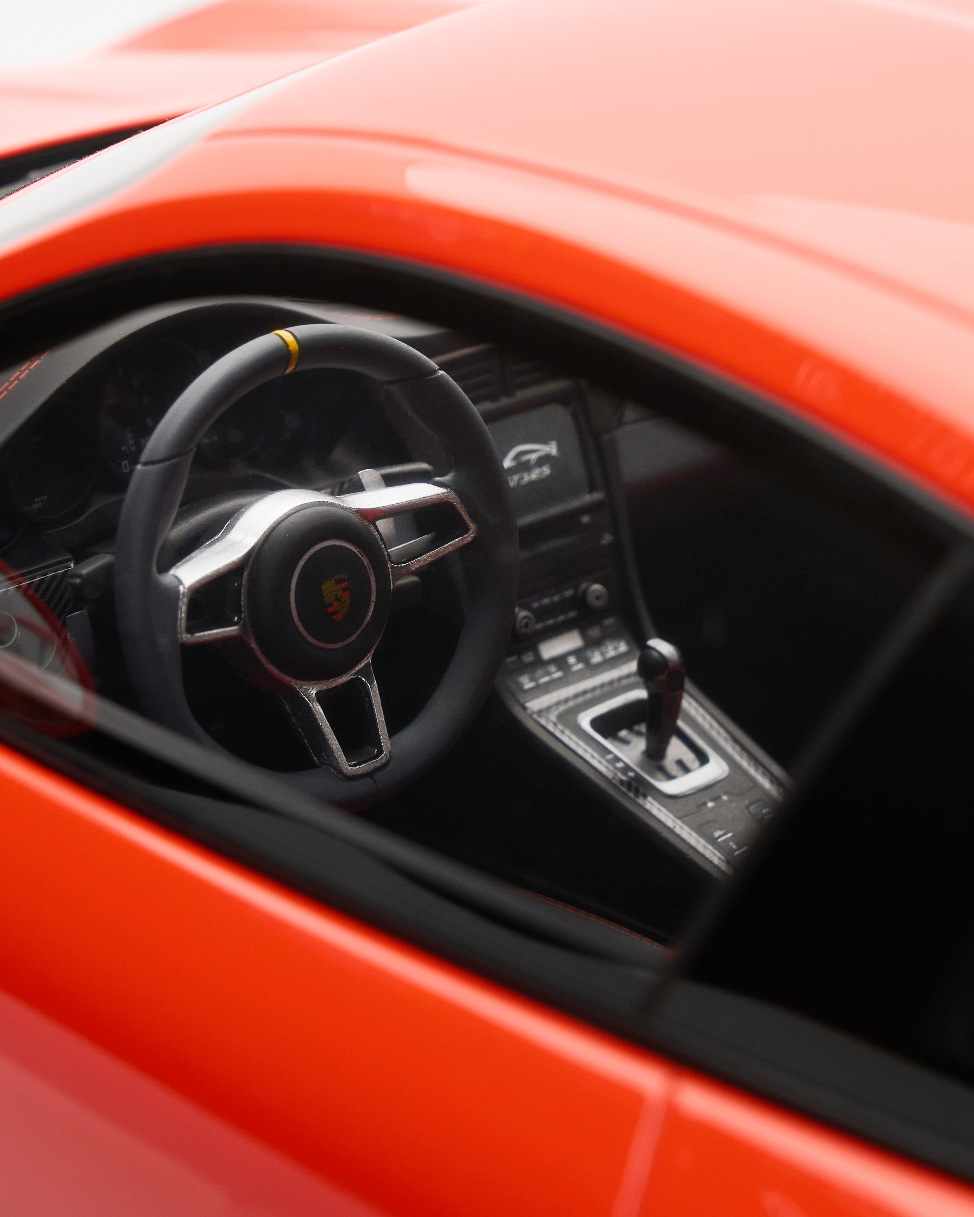 Porsche 911 GT3RS Lava Orange scale model car's steering wheel and interior
