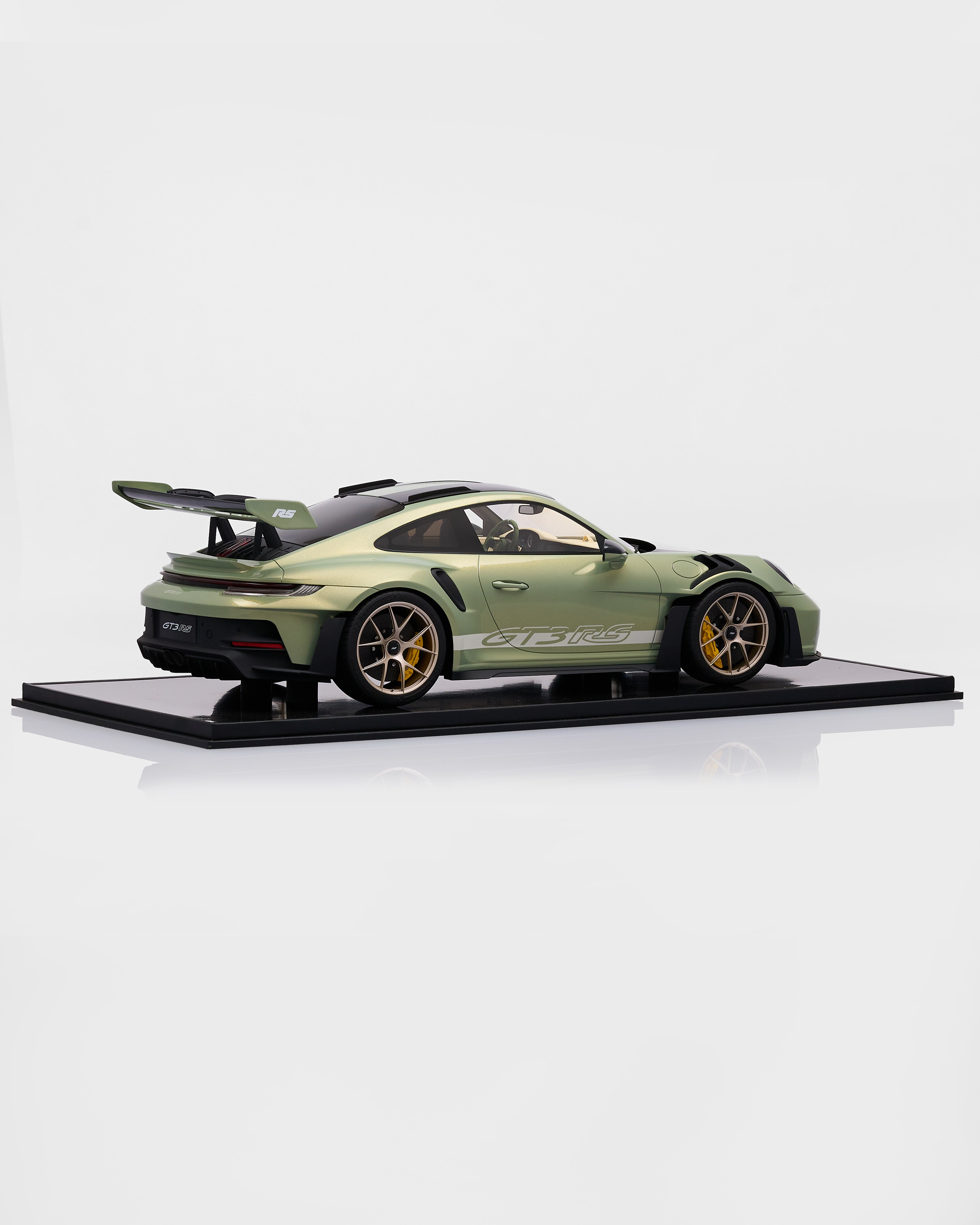 Model car Porsche 911 GT3RS Nato Olive Green on a display stand with a white background