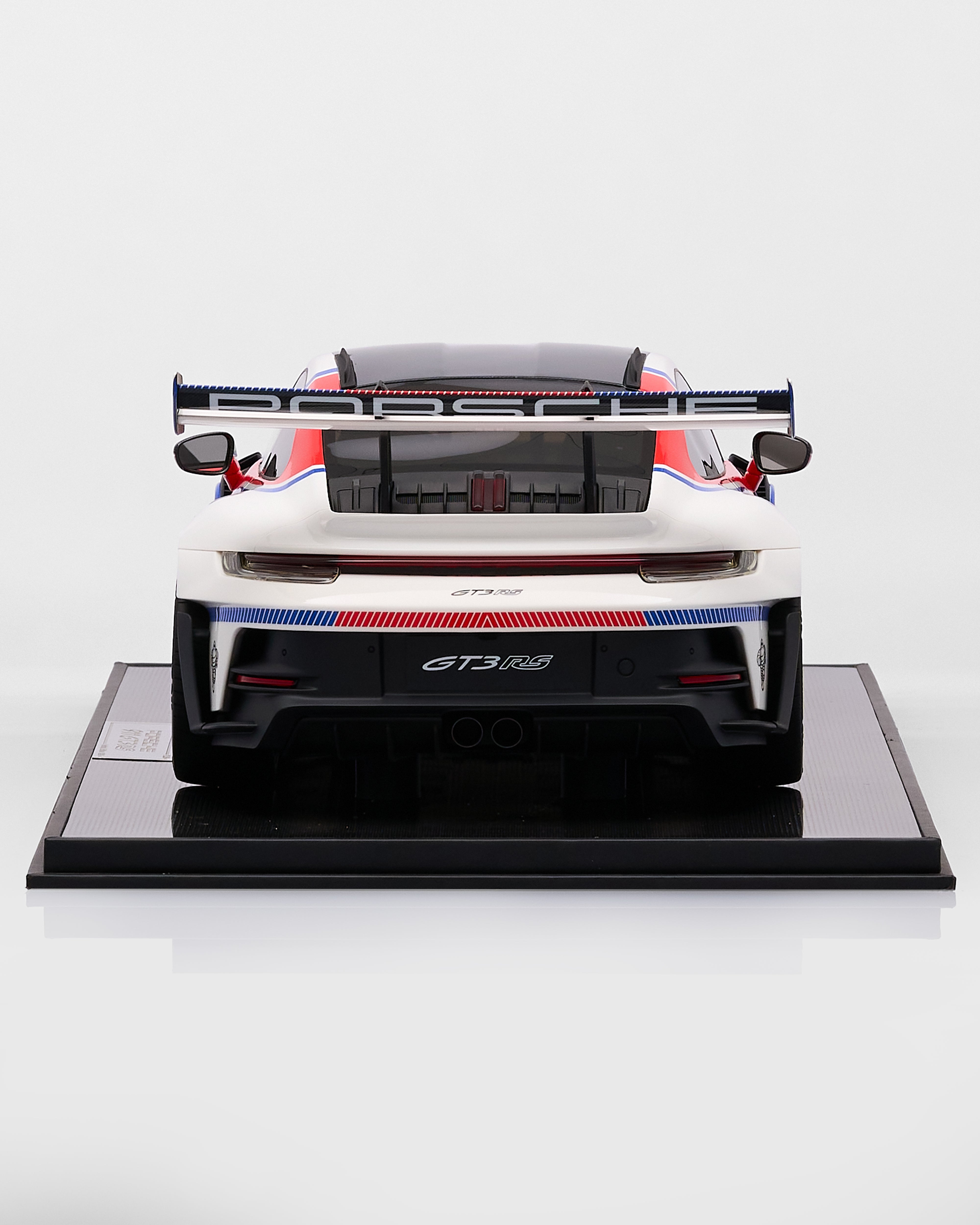 Porsche 911 GT3RS R Rennsport car on a black platform with a white background