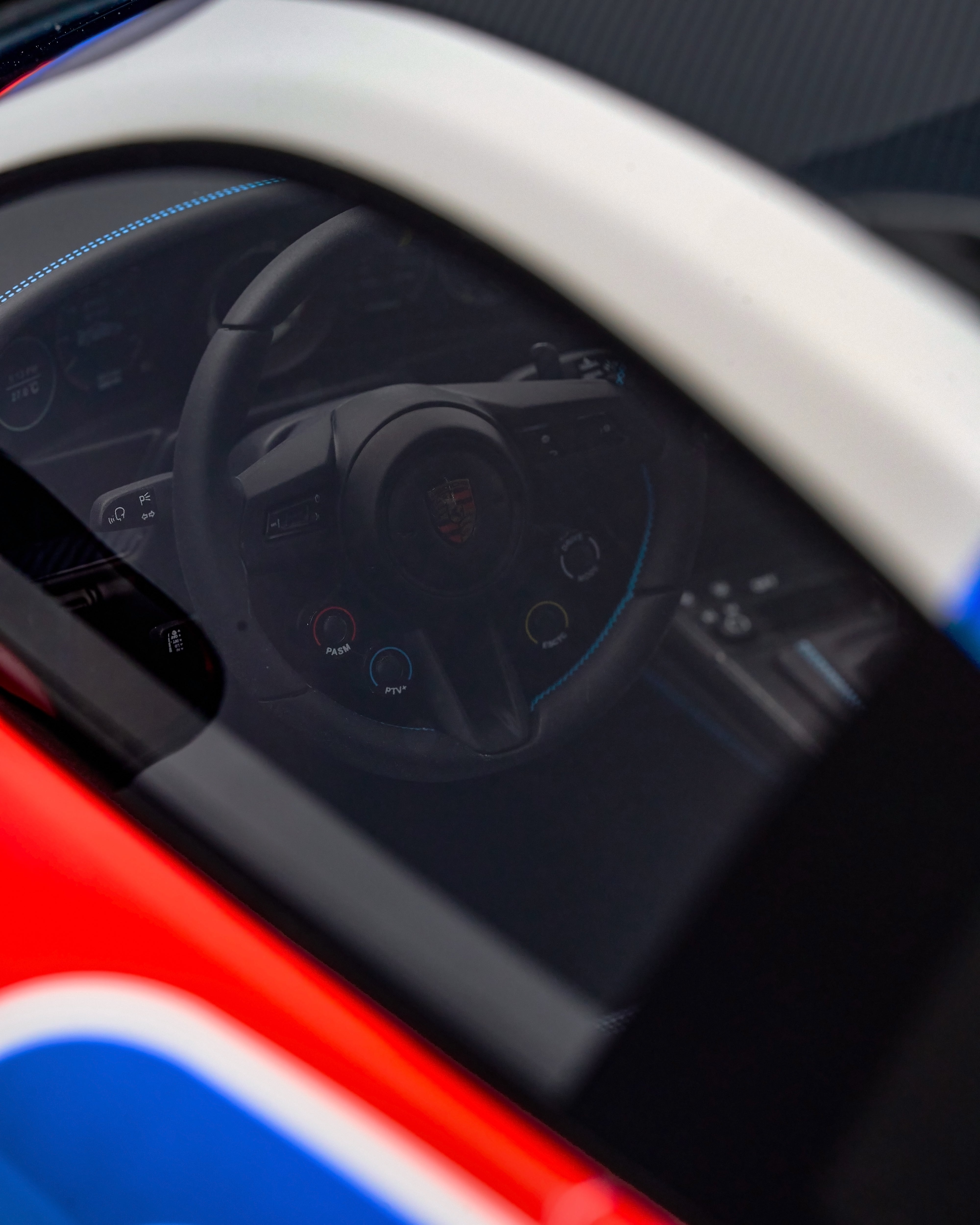 Close-up of a car's steering wheel and dashboard with a visible logo.