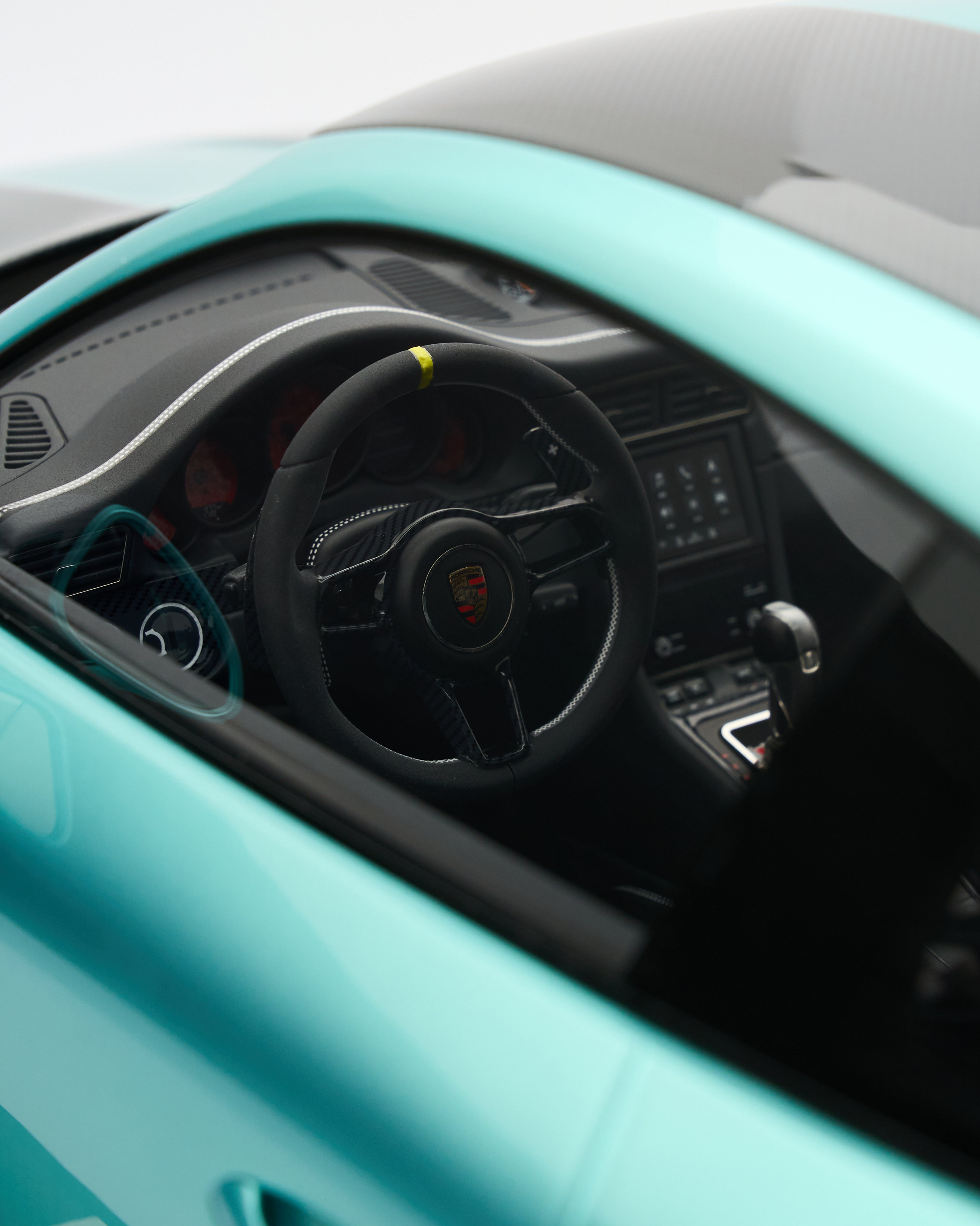 Close-up of a car's steering wheel and dashboard with a visible brand logo.