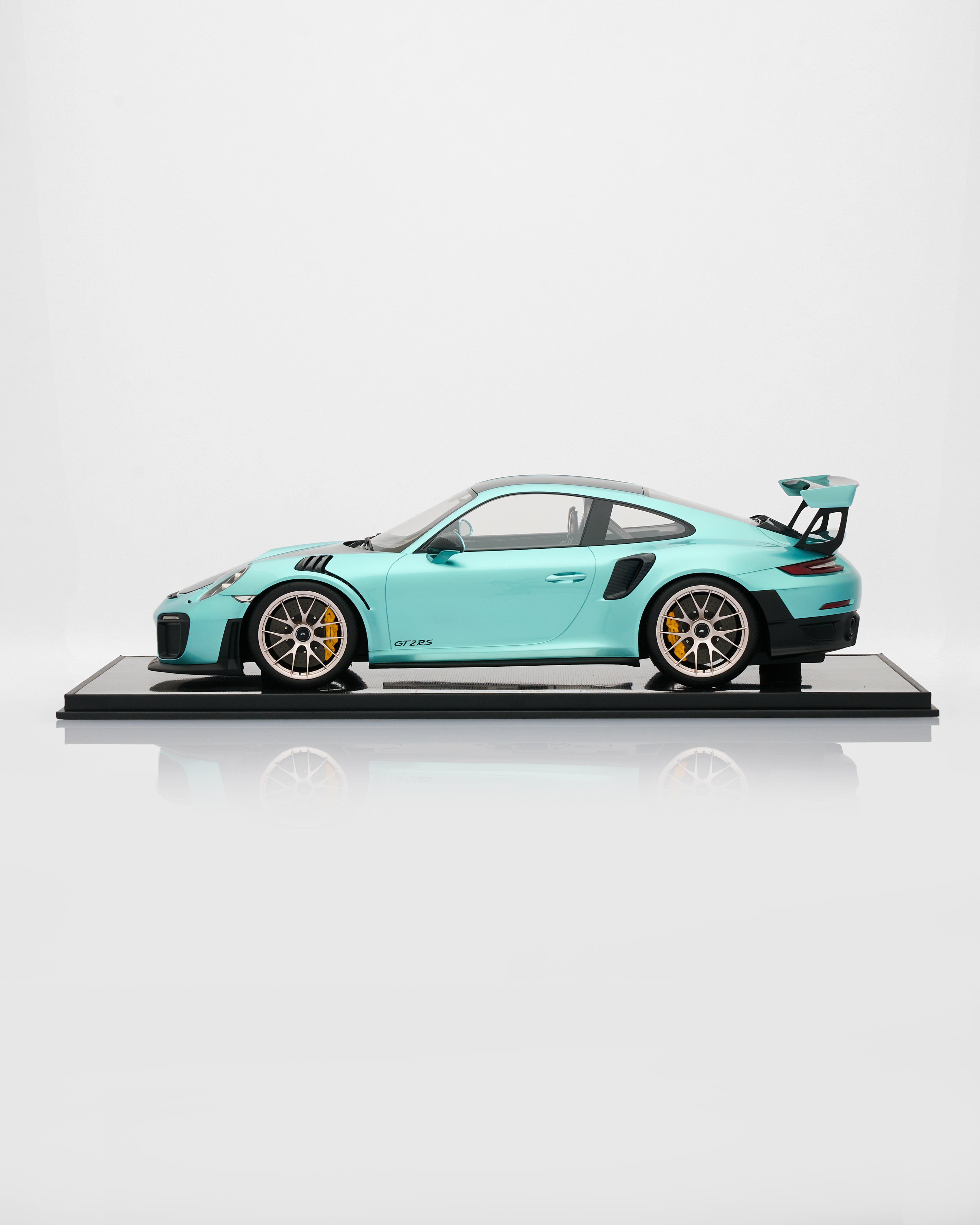 Model of a turquoise sports car on a white background