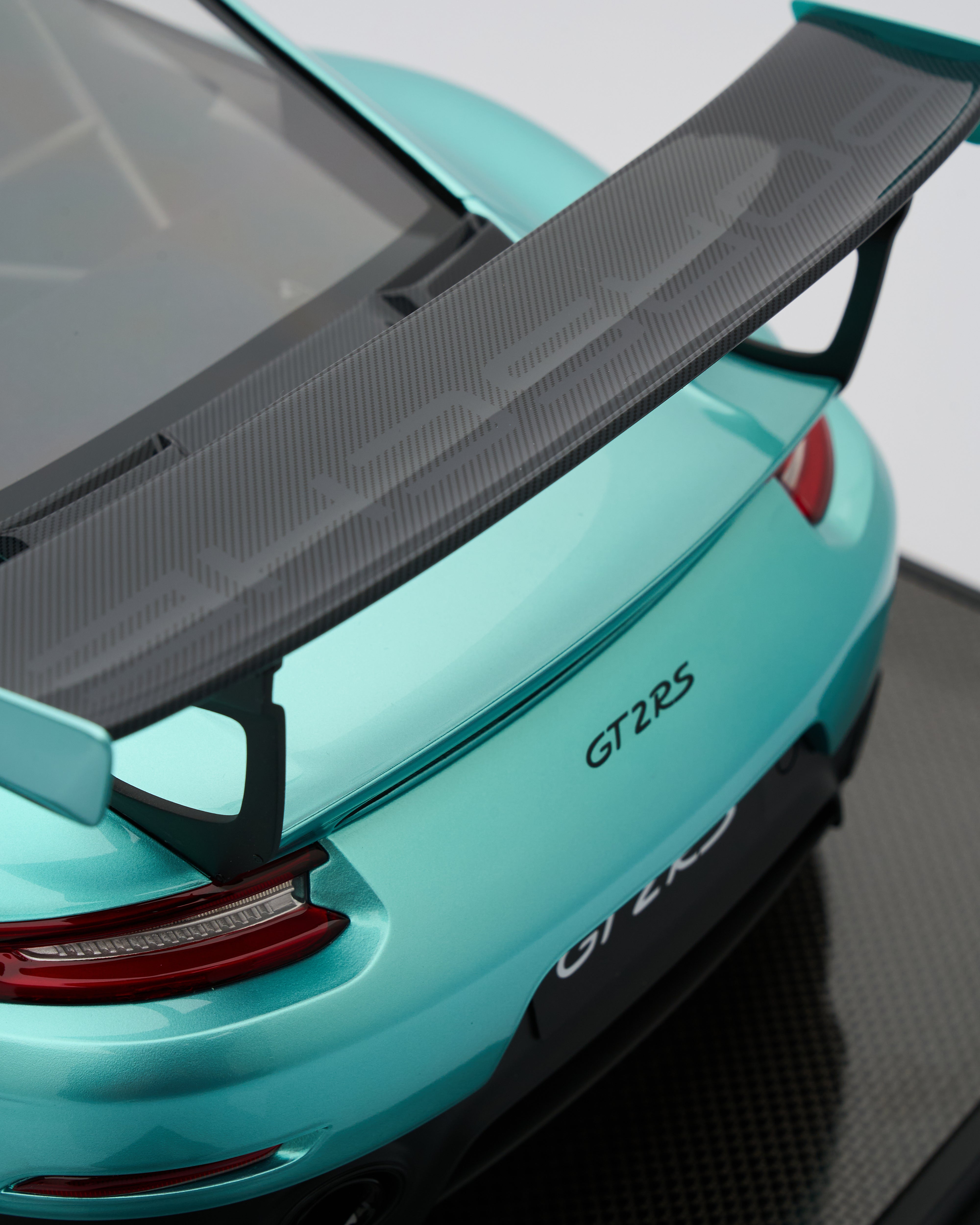 Porsche_GT2RS_Mint_Green_steering car with a black spoiler on a white background