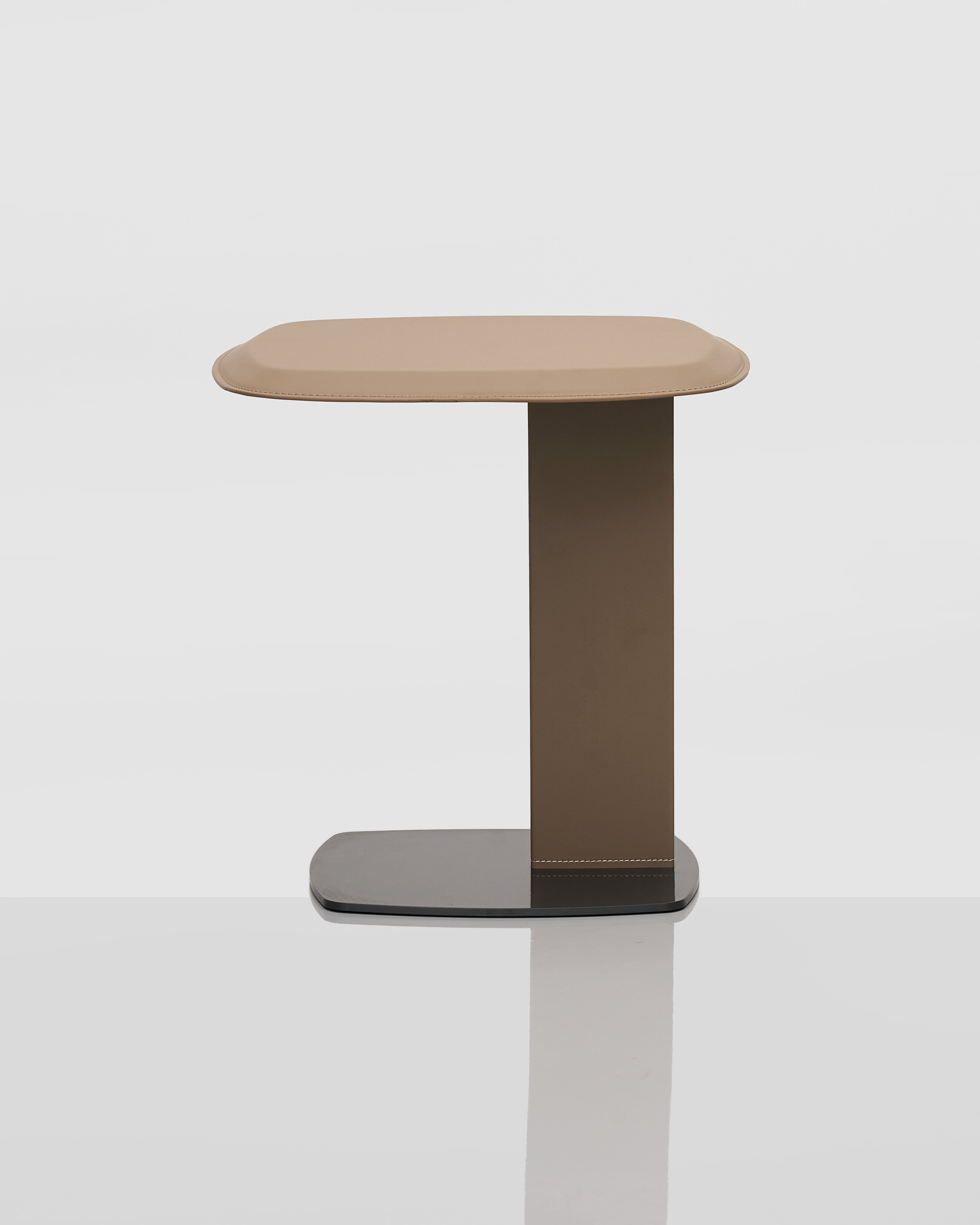 Minimalist side table with a square top and cylindrical base on a white background