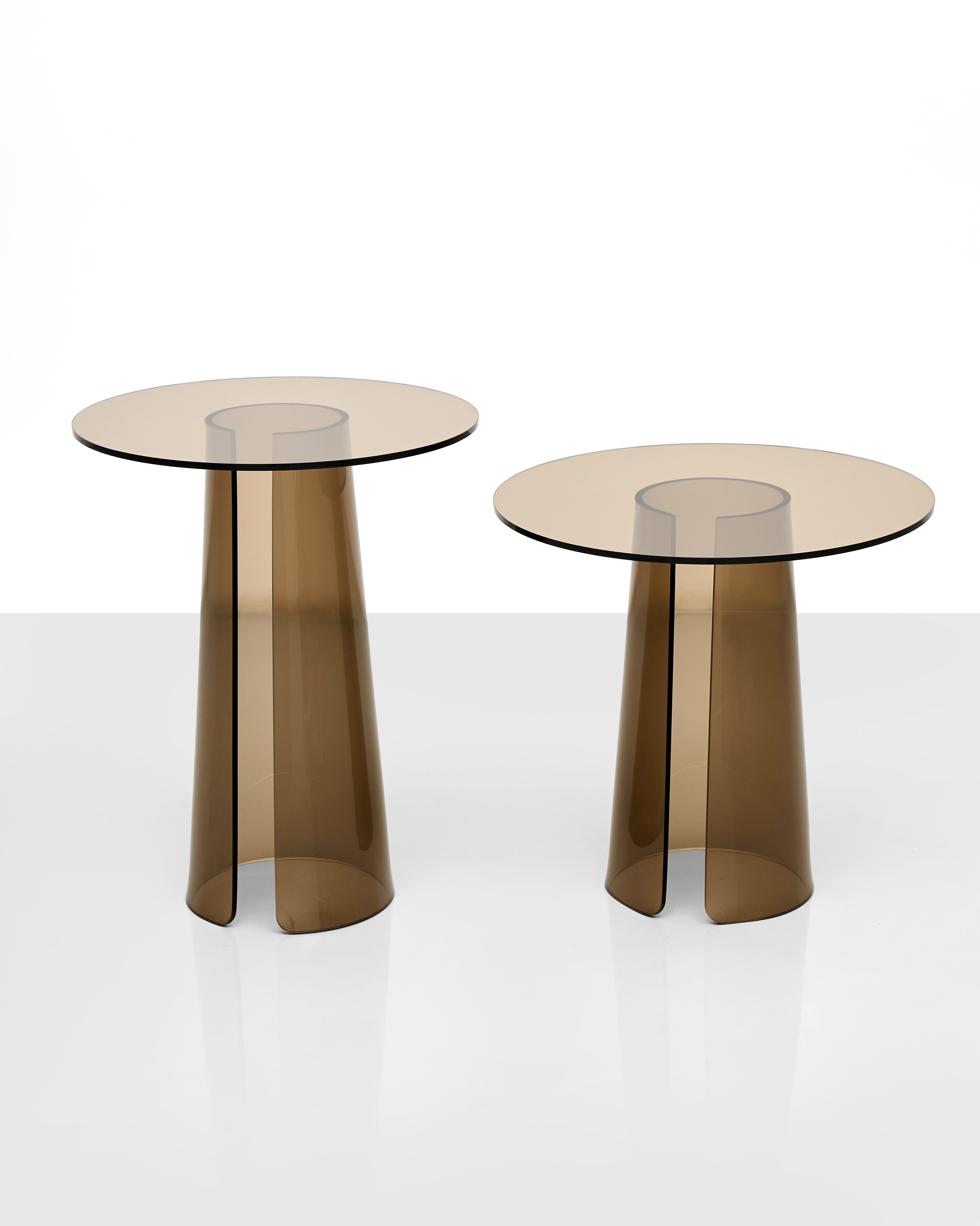Two acrylic side tables with acrylic split legs on a white background