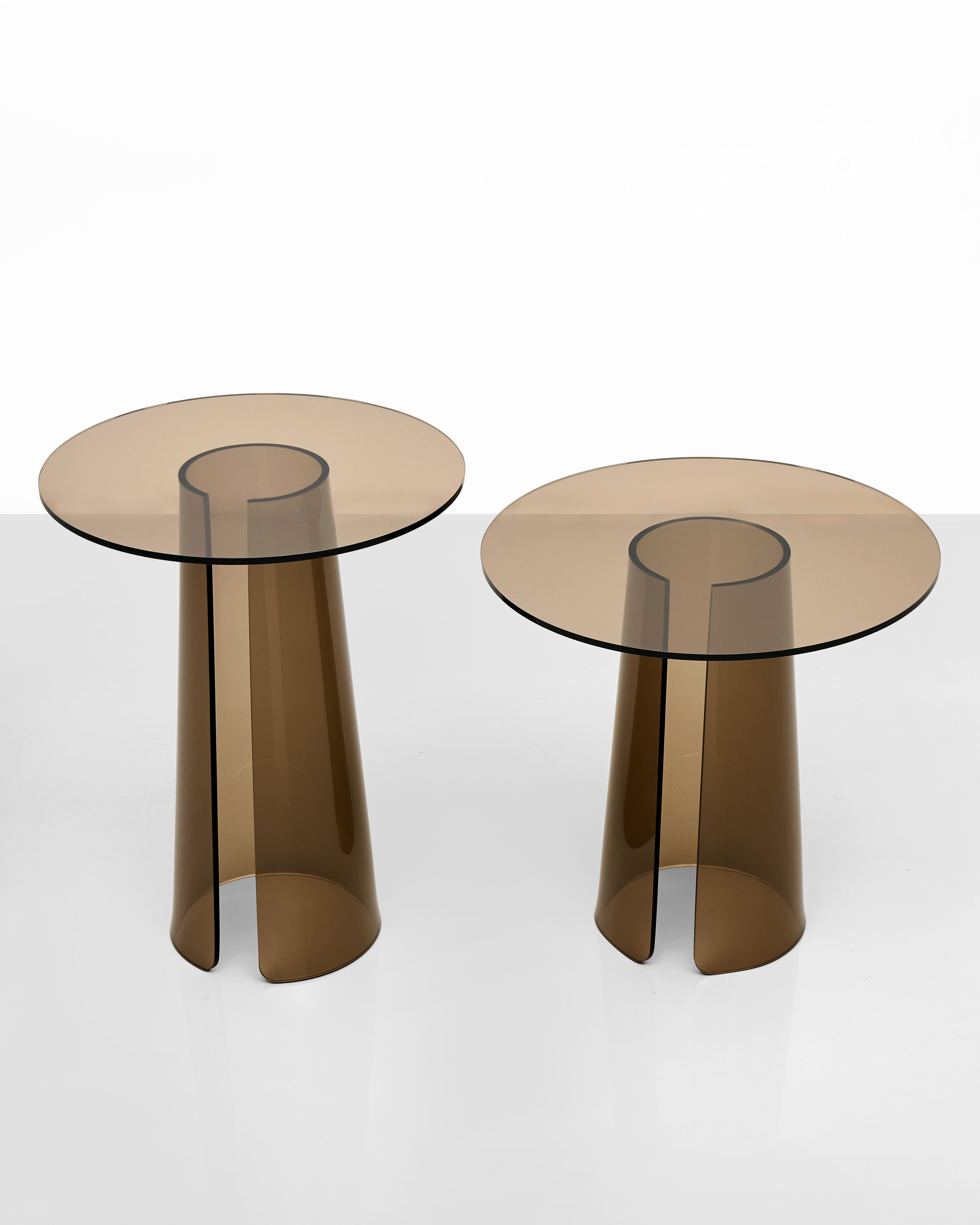Two modern side tables with smoked acrylic tops and cylindrical transparent bases on a white background.