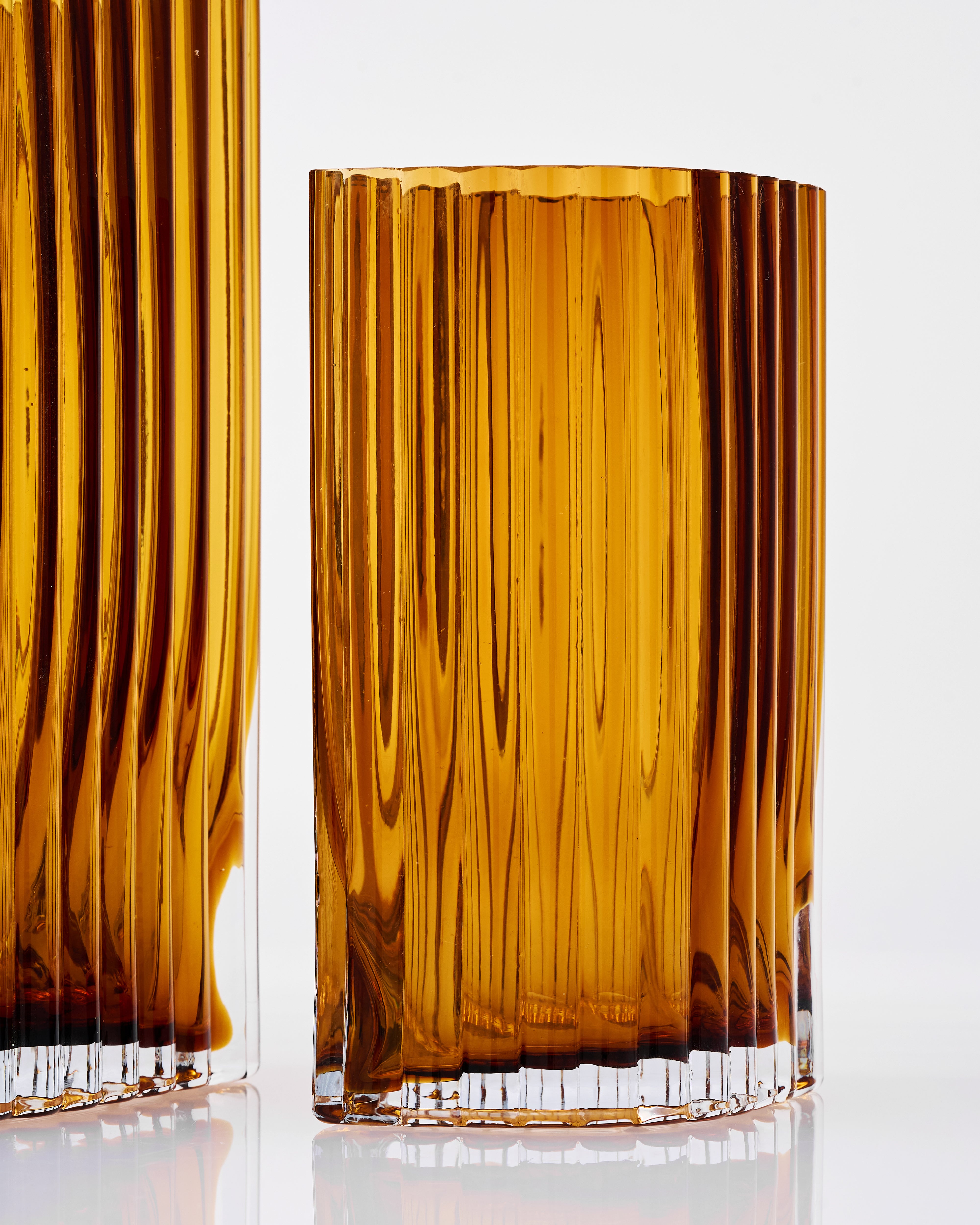 ribbed -patterned glass vase on a white background