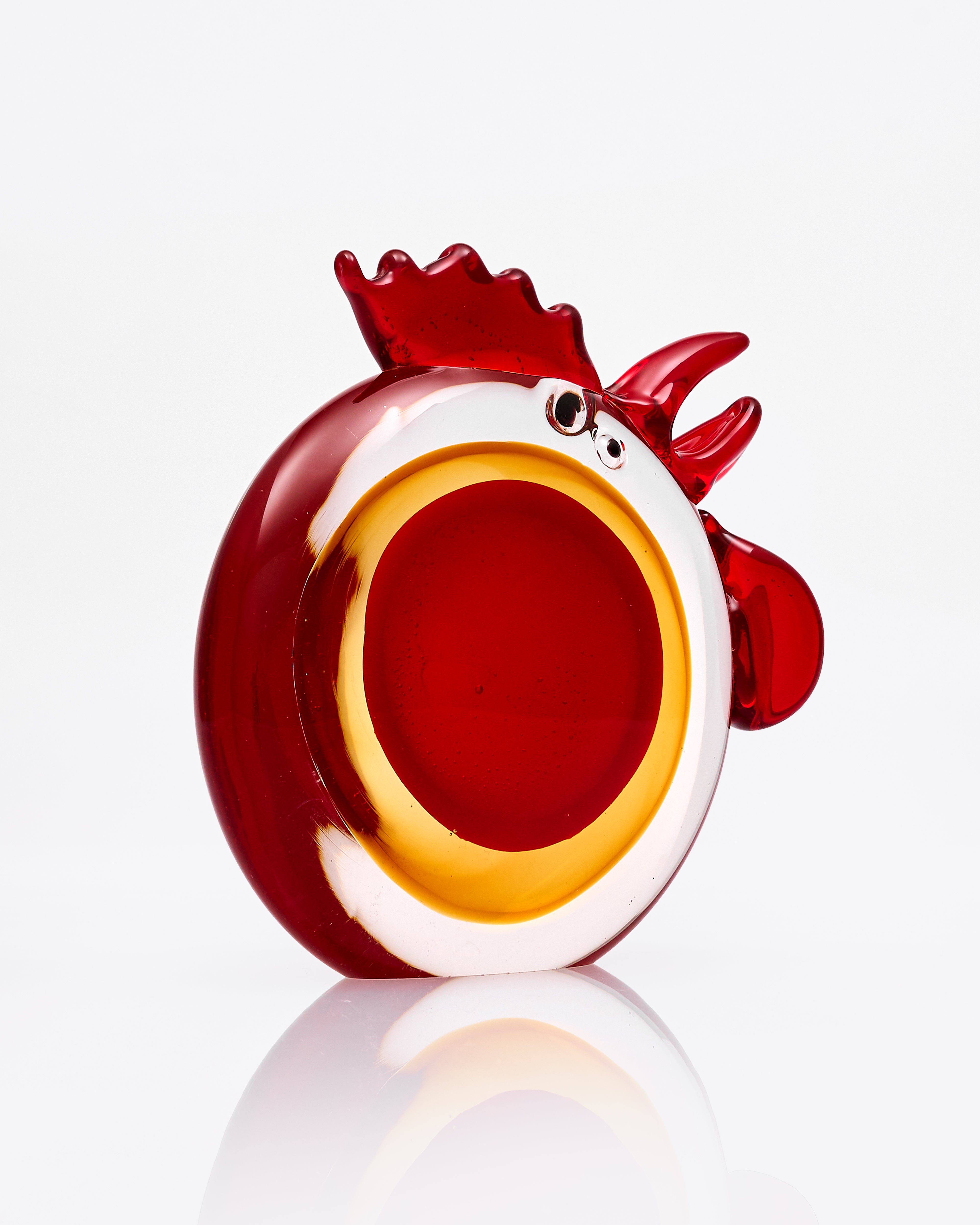 Glass rooster figurine on a white background