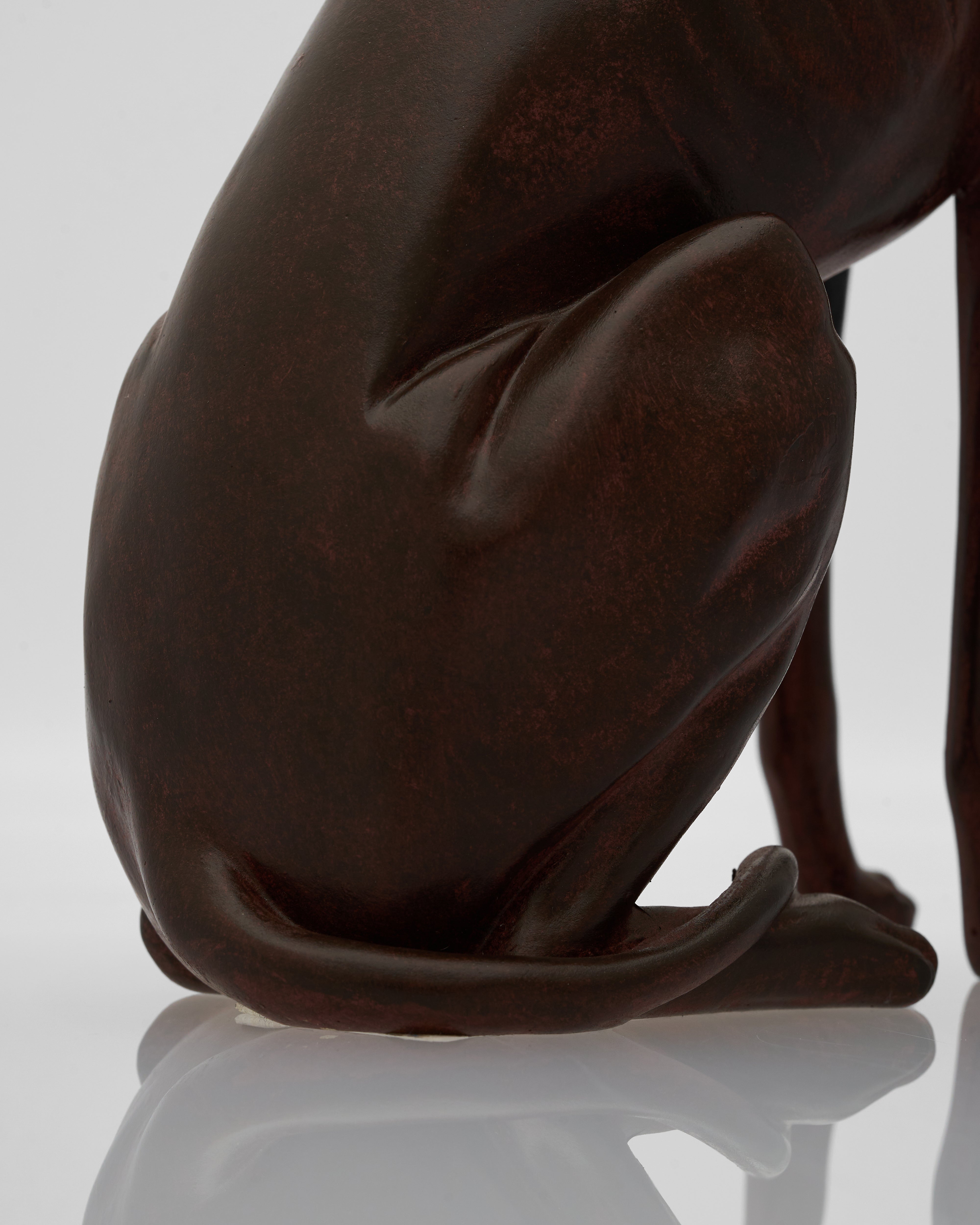wooden sculpture of a dog on a reflective surface with a white background