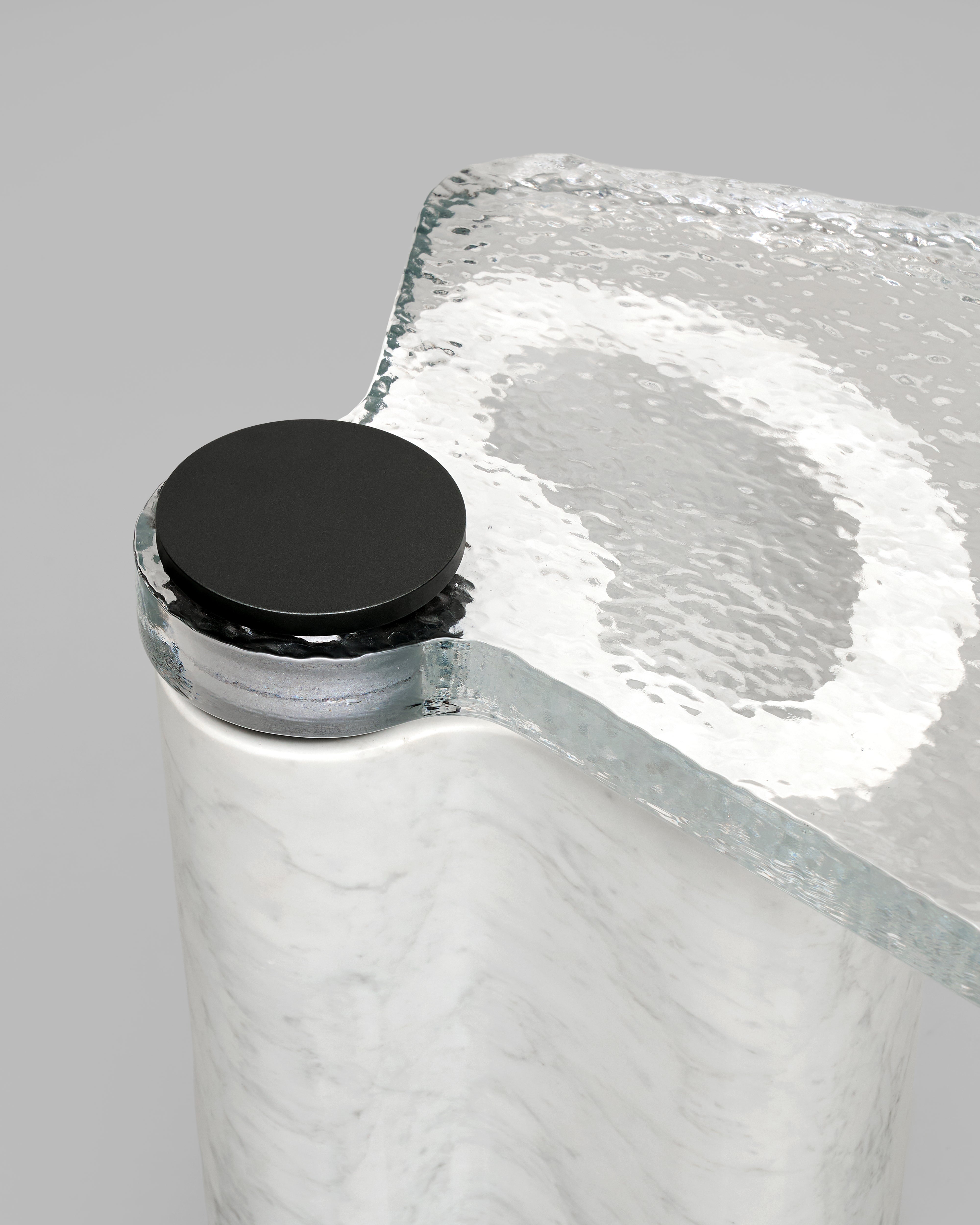 Clear glass side table with a black edge on a gray background
