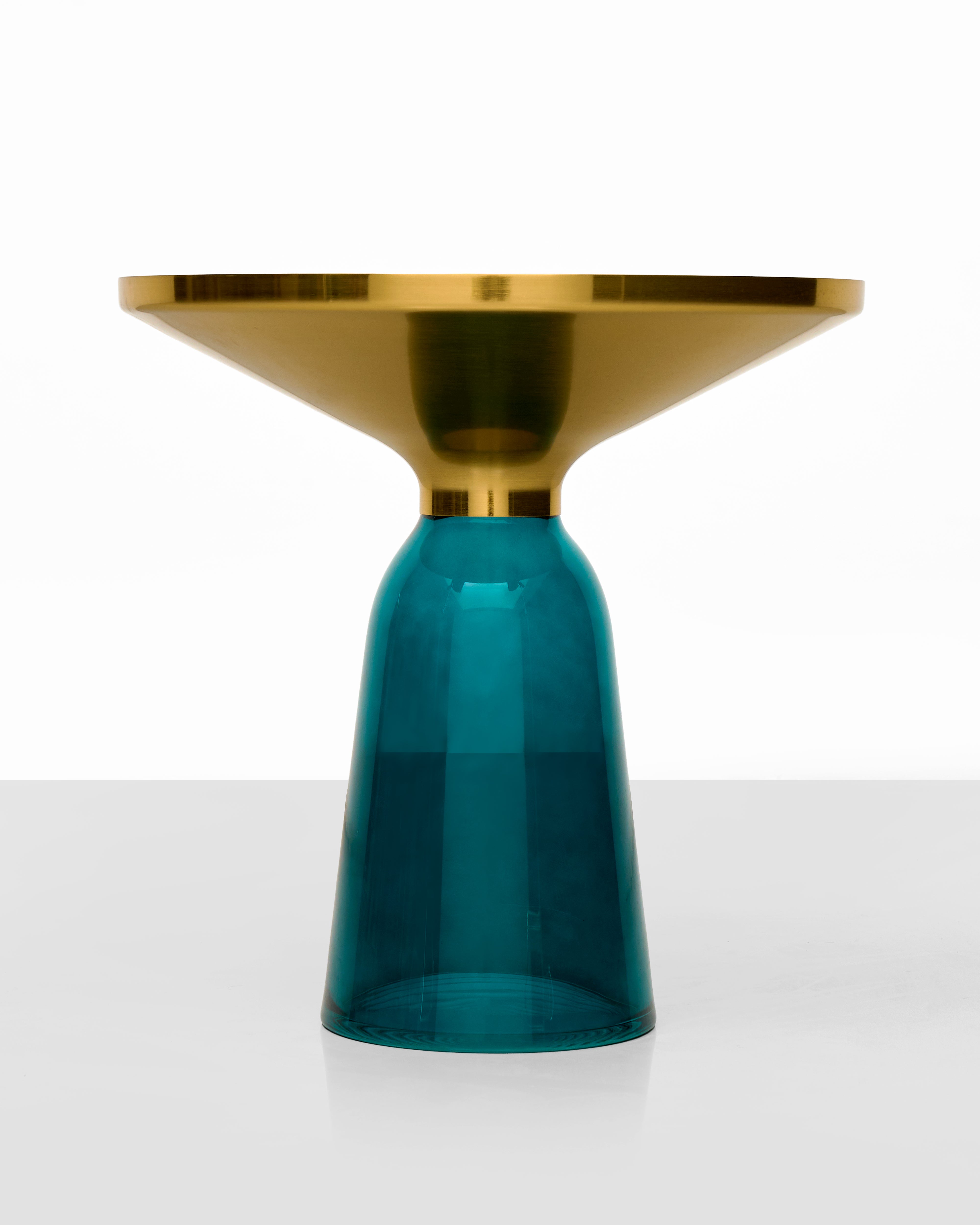 Gold and teal cylindrical object on a white background