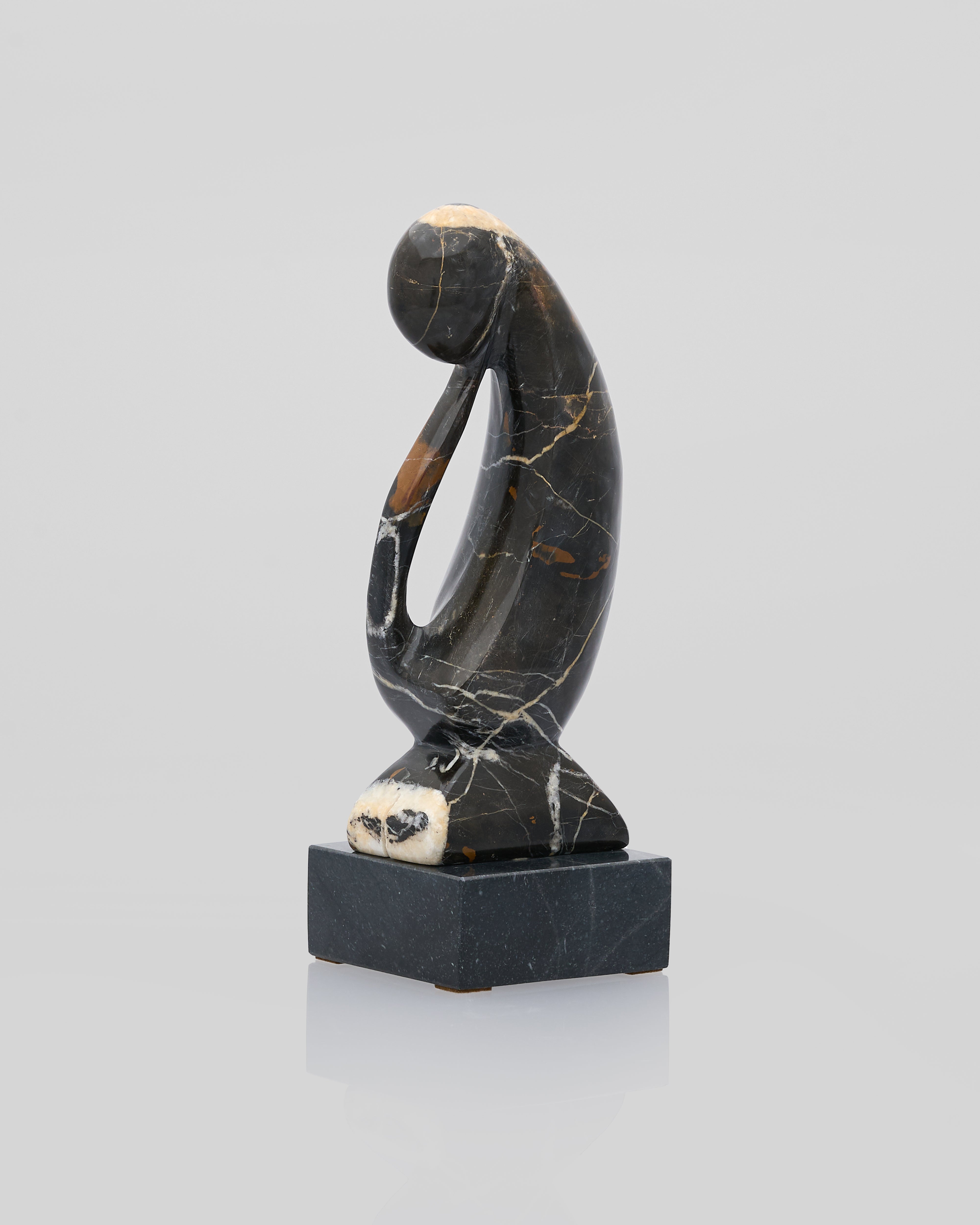 Black marble sculpture of a figure on a white background front view