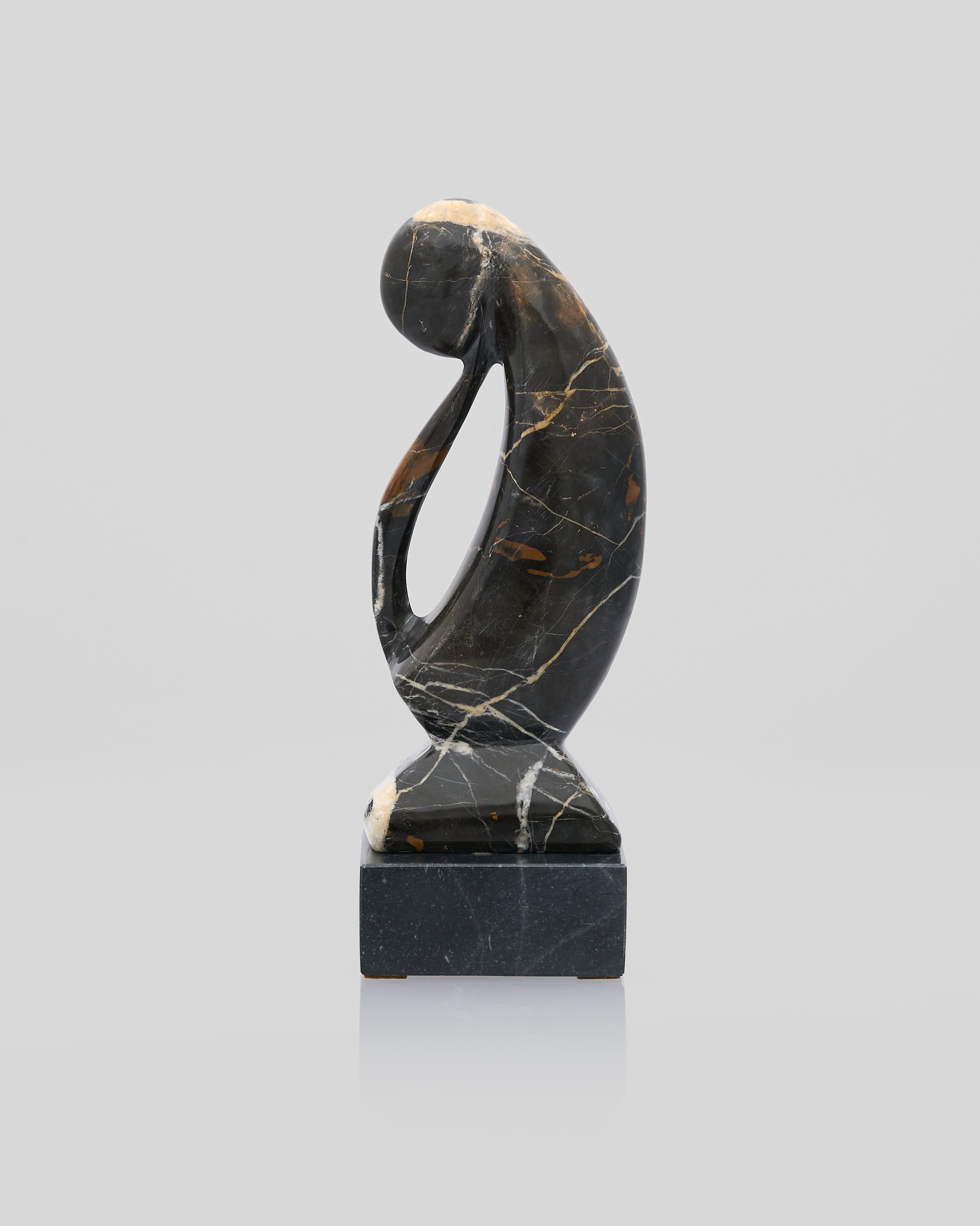 Black marble sculpture on a light gray background for hoe tabletop