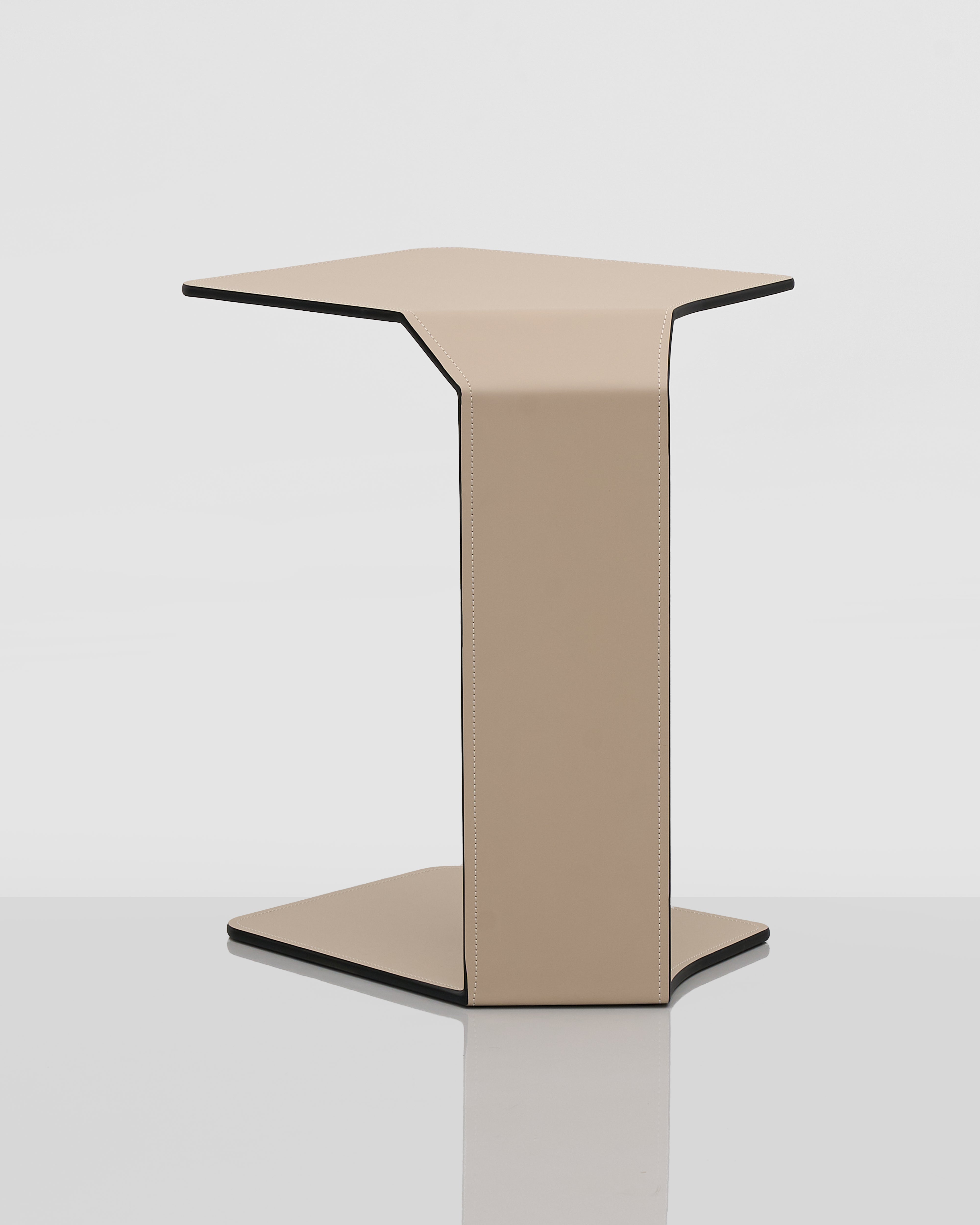 Beige side table with black trim on a white background