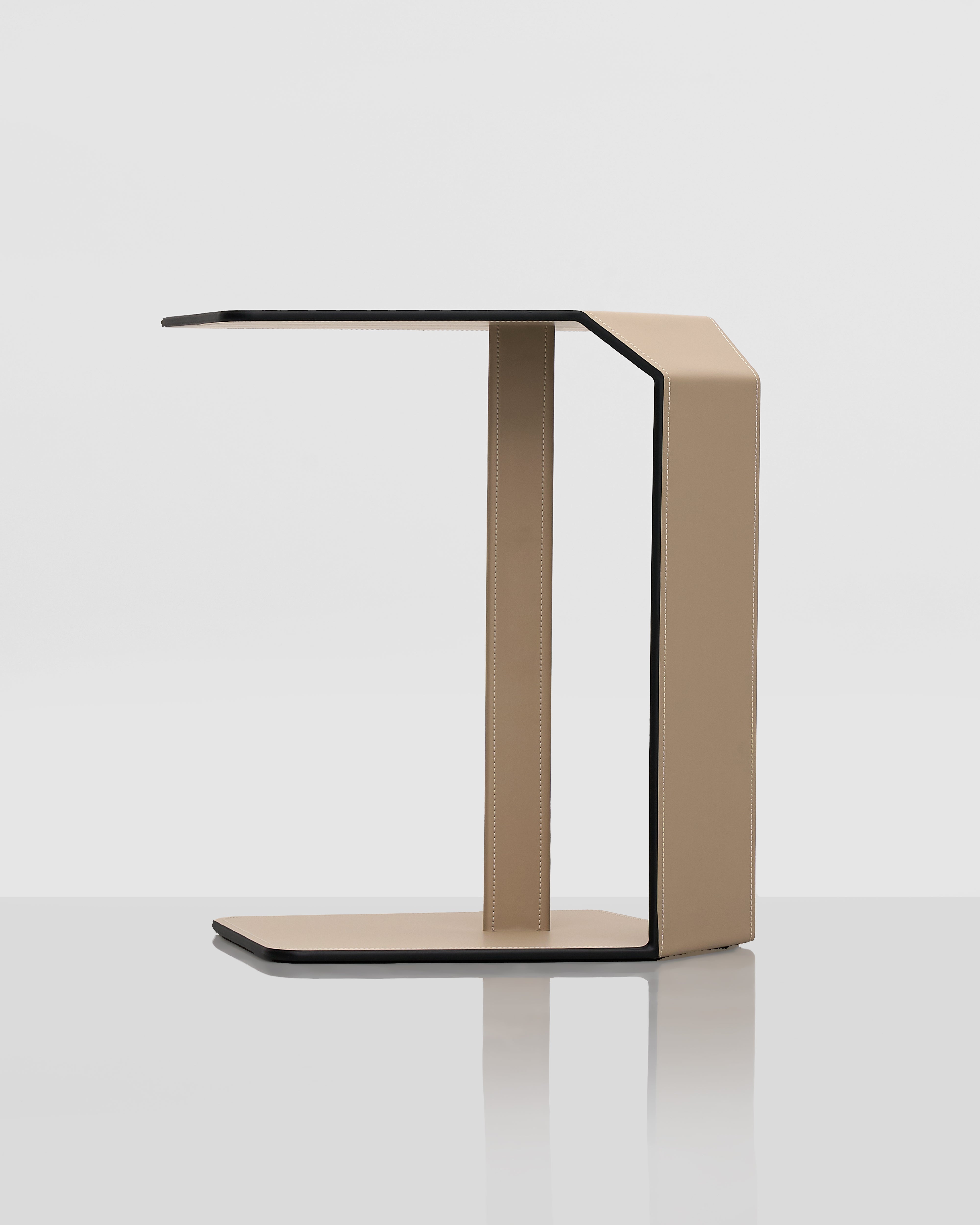 Modern side table with a geometric design on a white background and leather covering