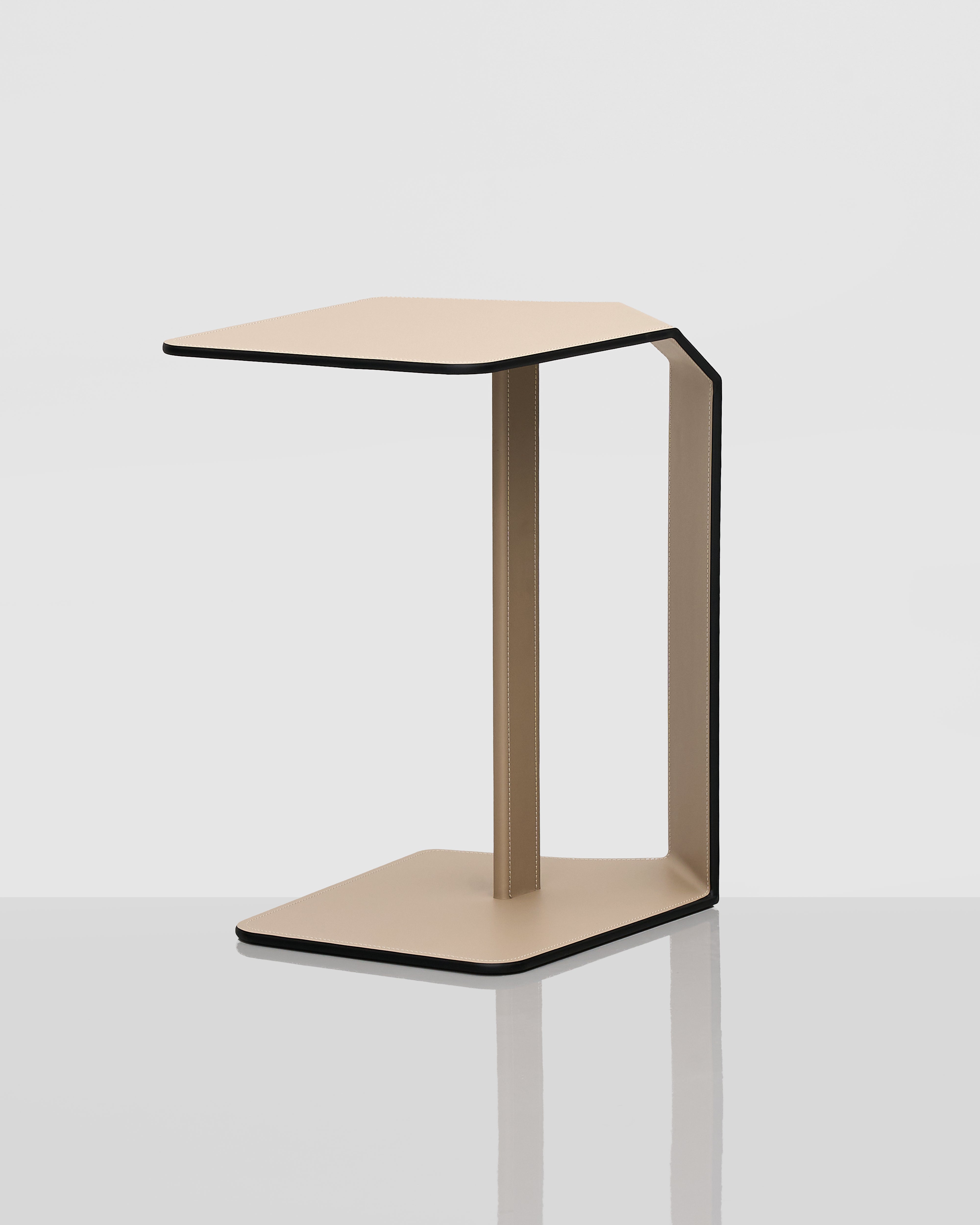 Modern side table with a geometric design on a white background adn leather covering