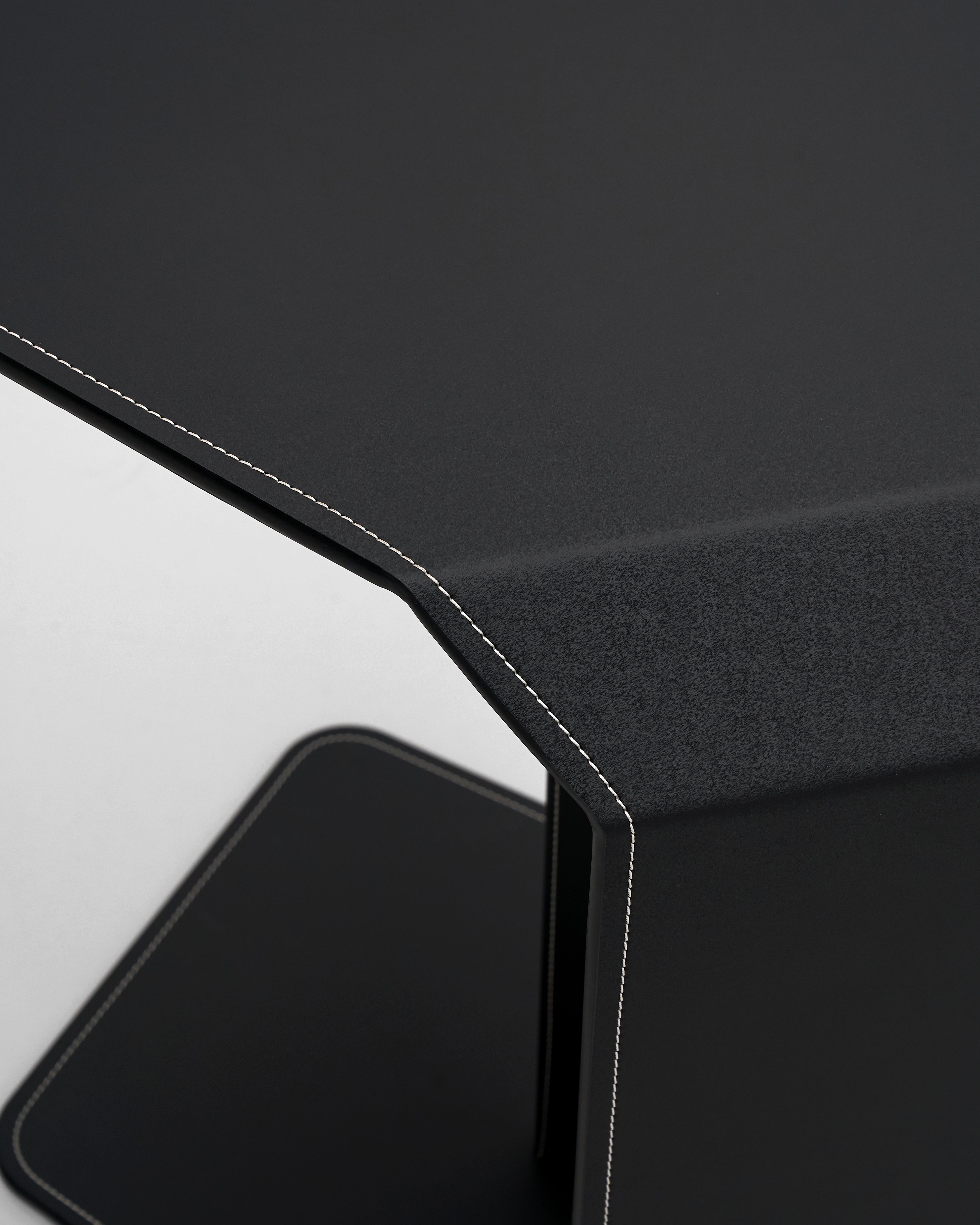 Close-up of a black and gray geometric object on a dark background